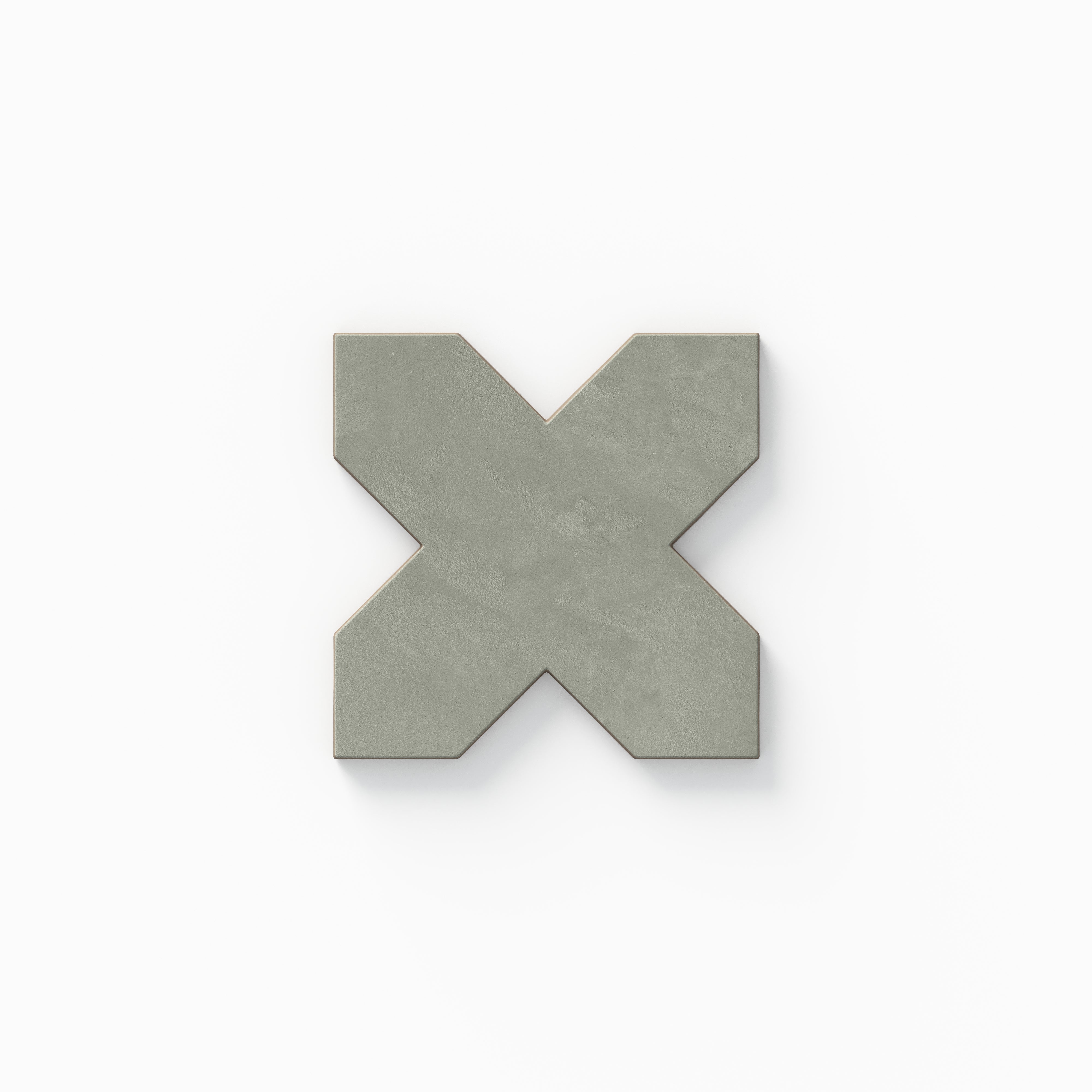 A decorative cross tile from our Isabel 11x11 Matte Porcelain Star and Cross set, featuring muted sage green tones and a soft cement-like texture finished with a powdery, aged look.