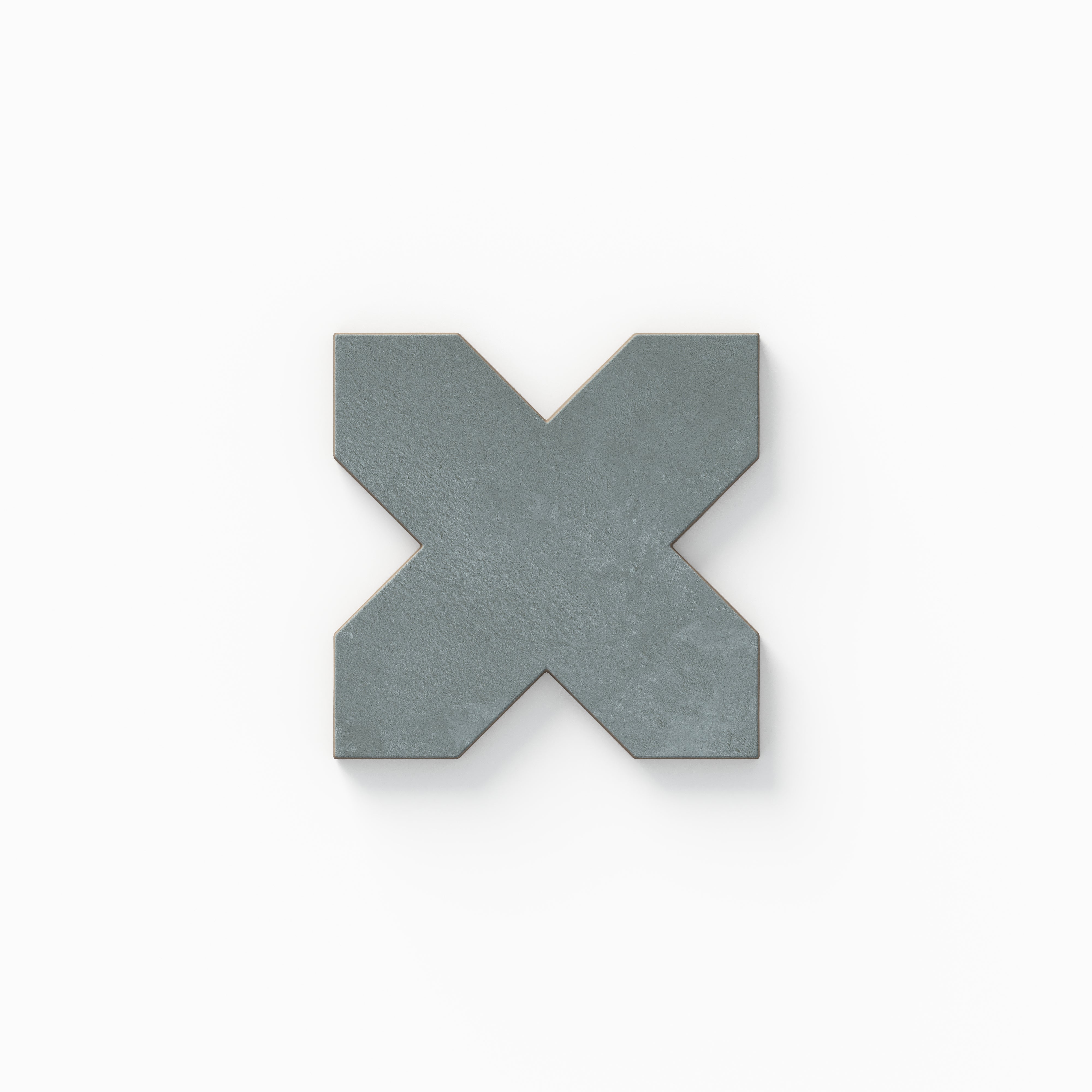 Isabel 11x11 Matte Porcelain Tile Star in Charcoal and Cross in Slate presents a traditional cross silhouette in soft blue with understated cement-plaster surface texture and a smooth matte look.
