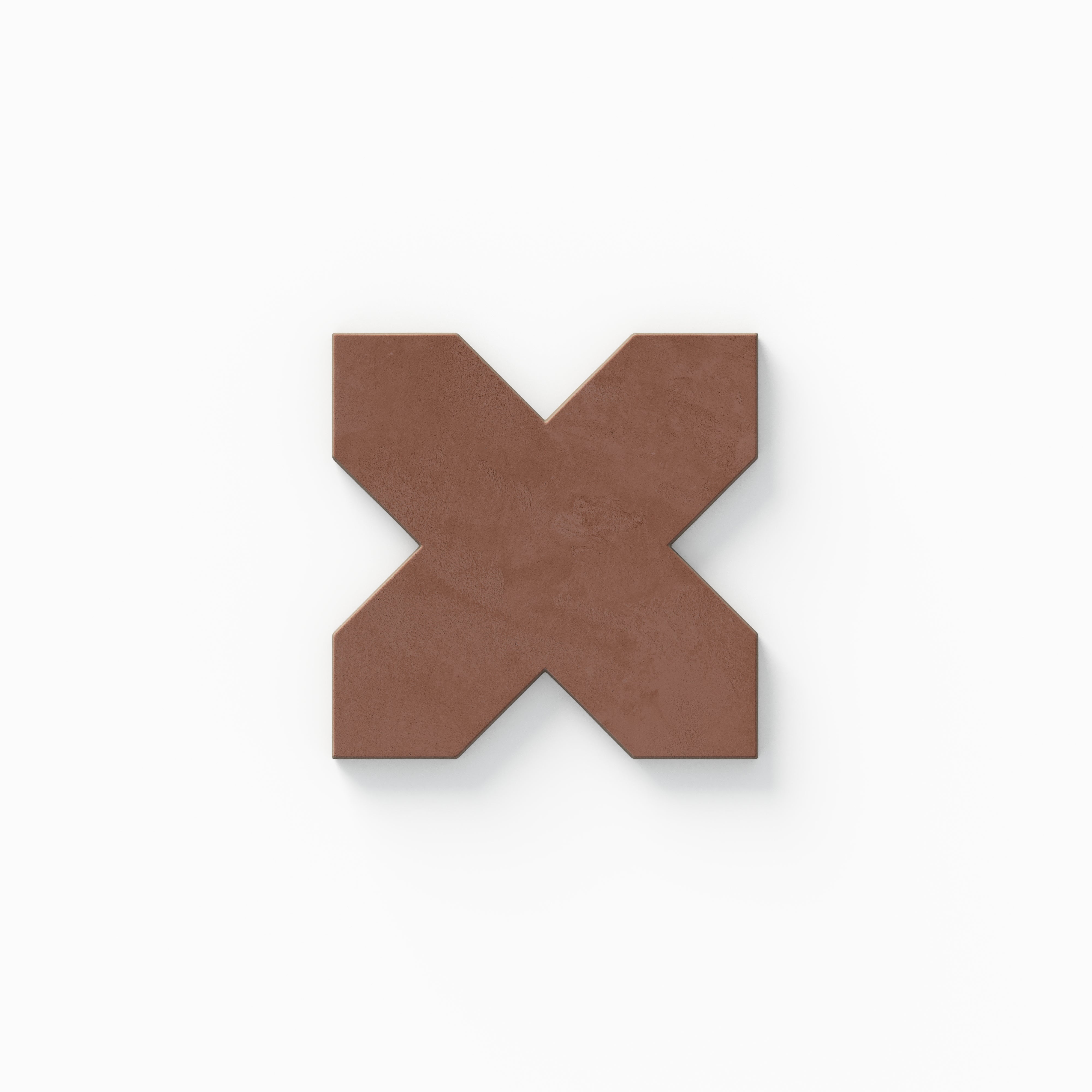 Isabel 11x11 Matte Porcelain Tile Star in Charcoal and Cross in Rust shows a timeless cross form in warm red with gentle cement-plaster texture and a powdery matte surface.