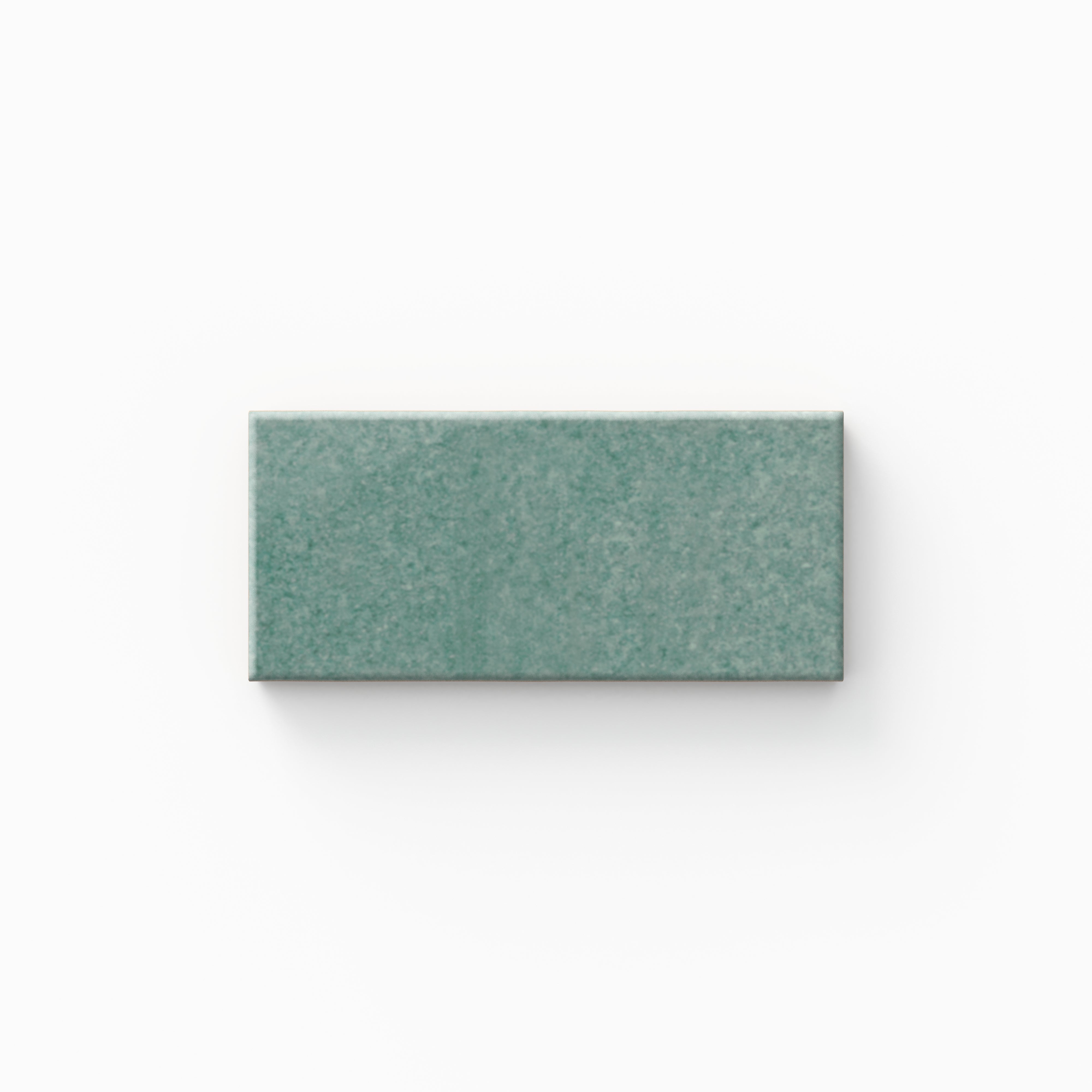 A calming seafoam tile features subtle tonal shifts and a glossy finish, bringing a fresh, airy feel that works beautifully in coastal, spa-like bathrooms.