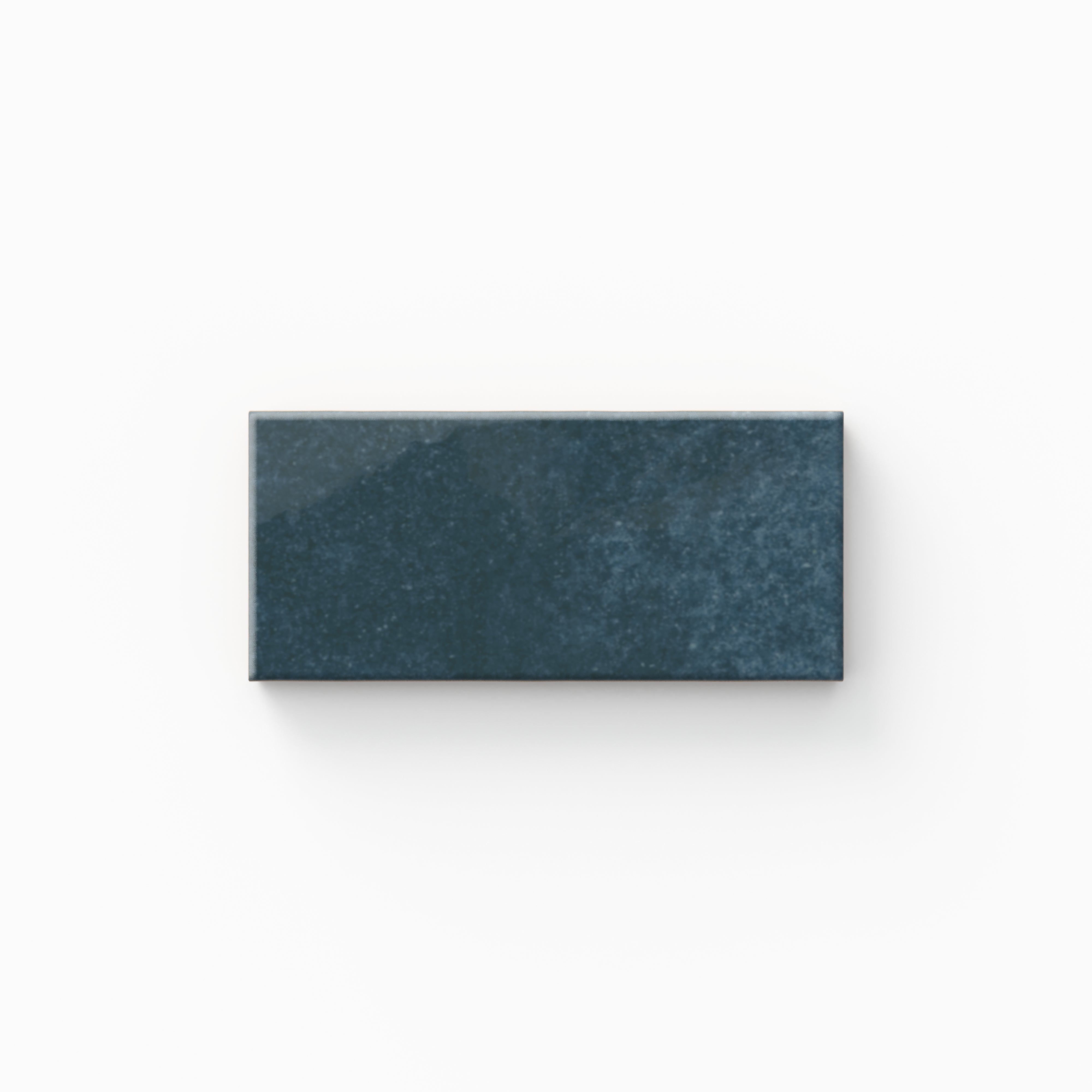 A rich marine blue tile shows subtle surface variation and a glossy finish, echoing the depth of seawater and fitting naturally into coastal, spa-inspired interiors.