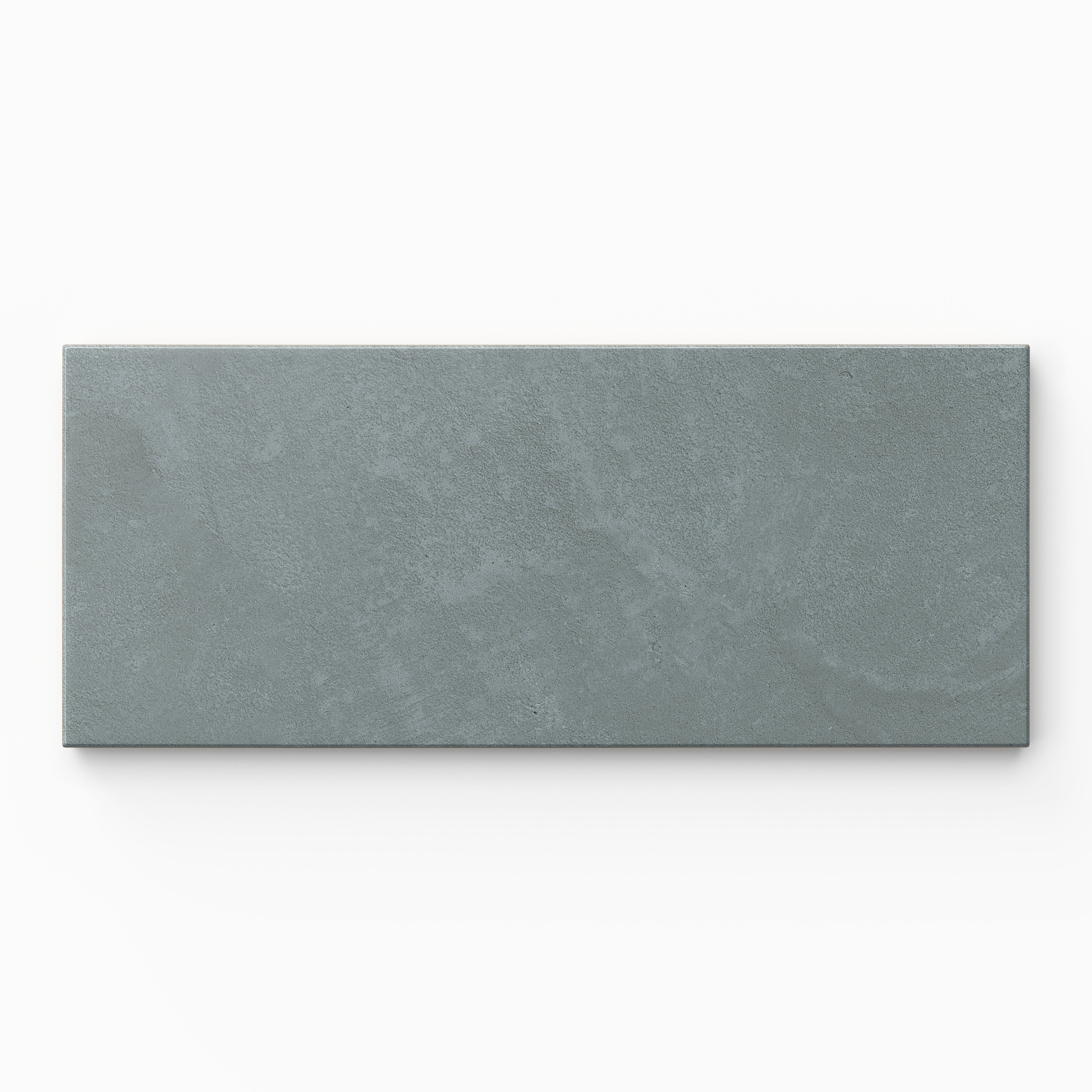Isabel 2.5x12 Matte Porcelain Tile in Slate highlights an elongated subway shape with muted blue shading, quiet surface texture, and a soft cement-plaster finish.