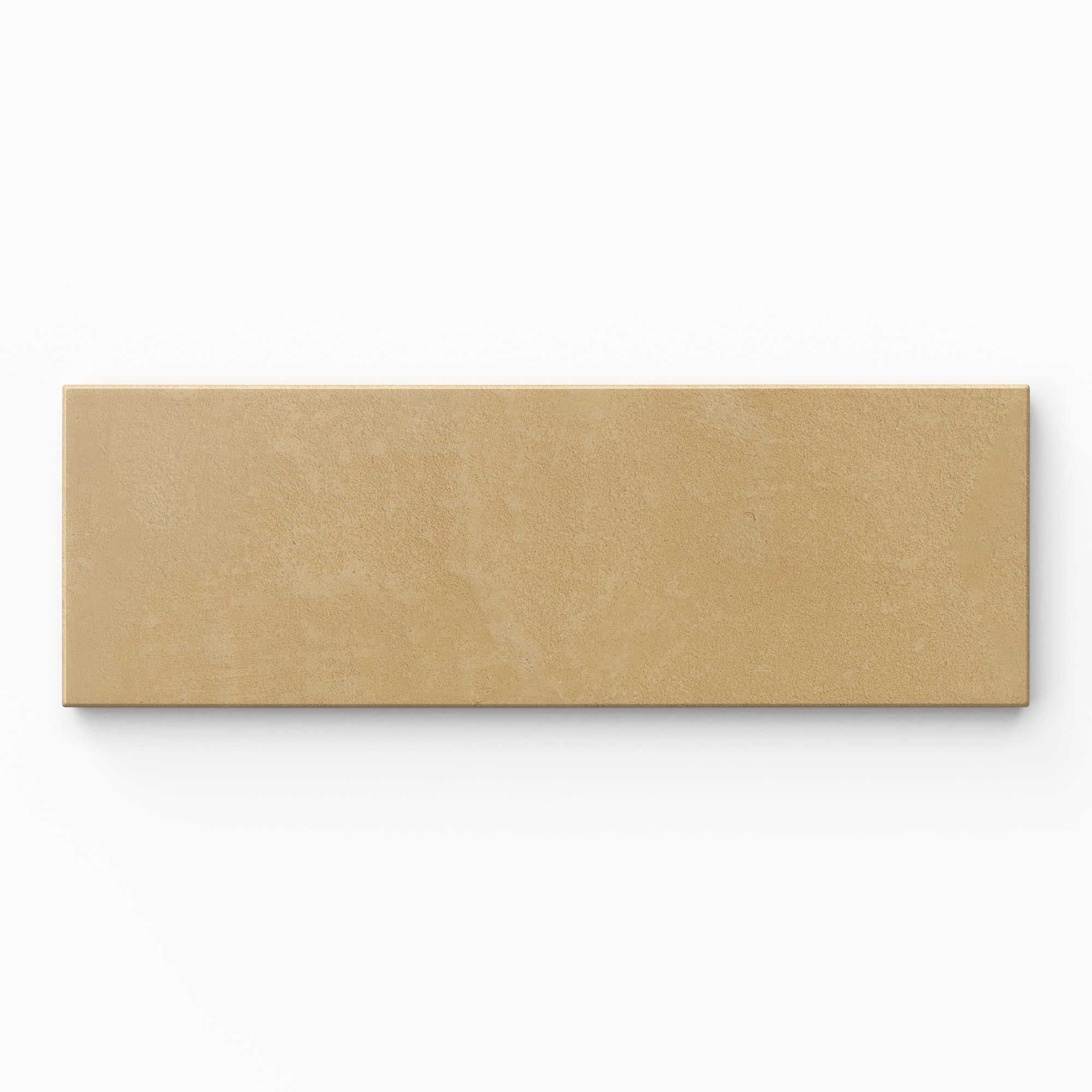 Isabel 2x6 Matte Porcelain Tile in Daffodil highlights a modern subway shape with earth-toned yellow-orange shading, a powdery glaze, and lightly textured cement-plaster character.