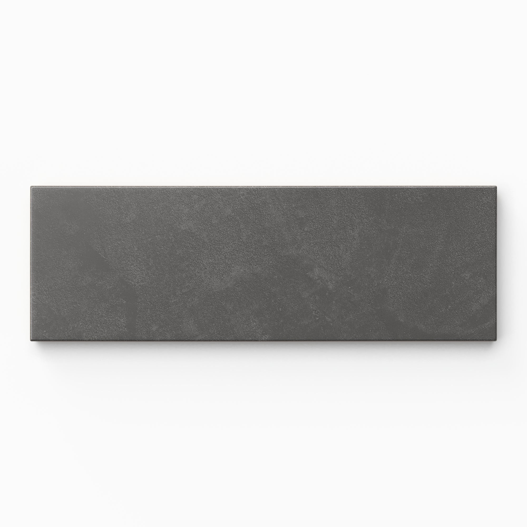 Isabel 2x6 Matte Porcelain Tile in Charcoal shows a matte dark gray finish with gentle surface variation and a powdery glaze that gives it a grounded, natural look.