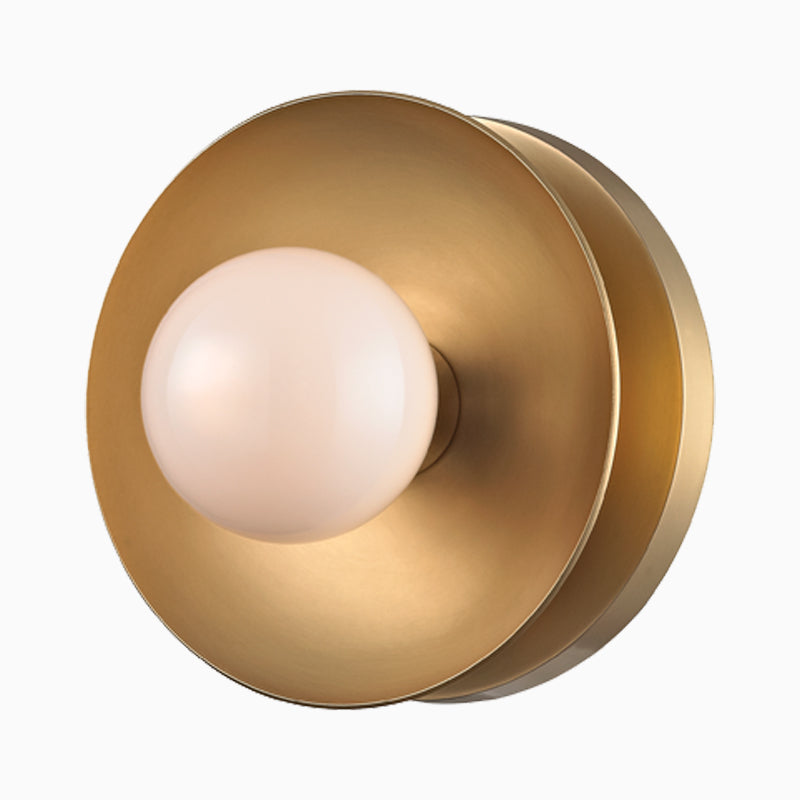 Aged brass bath and vanity light with a slim horizontal bar and round white glass shades for a clean modern look.