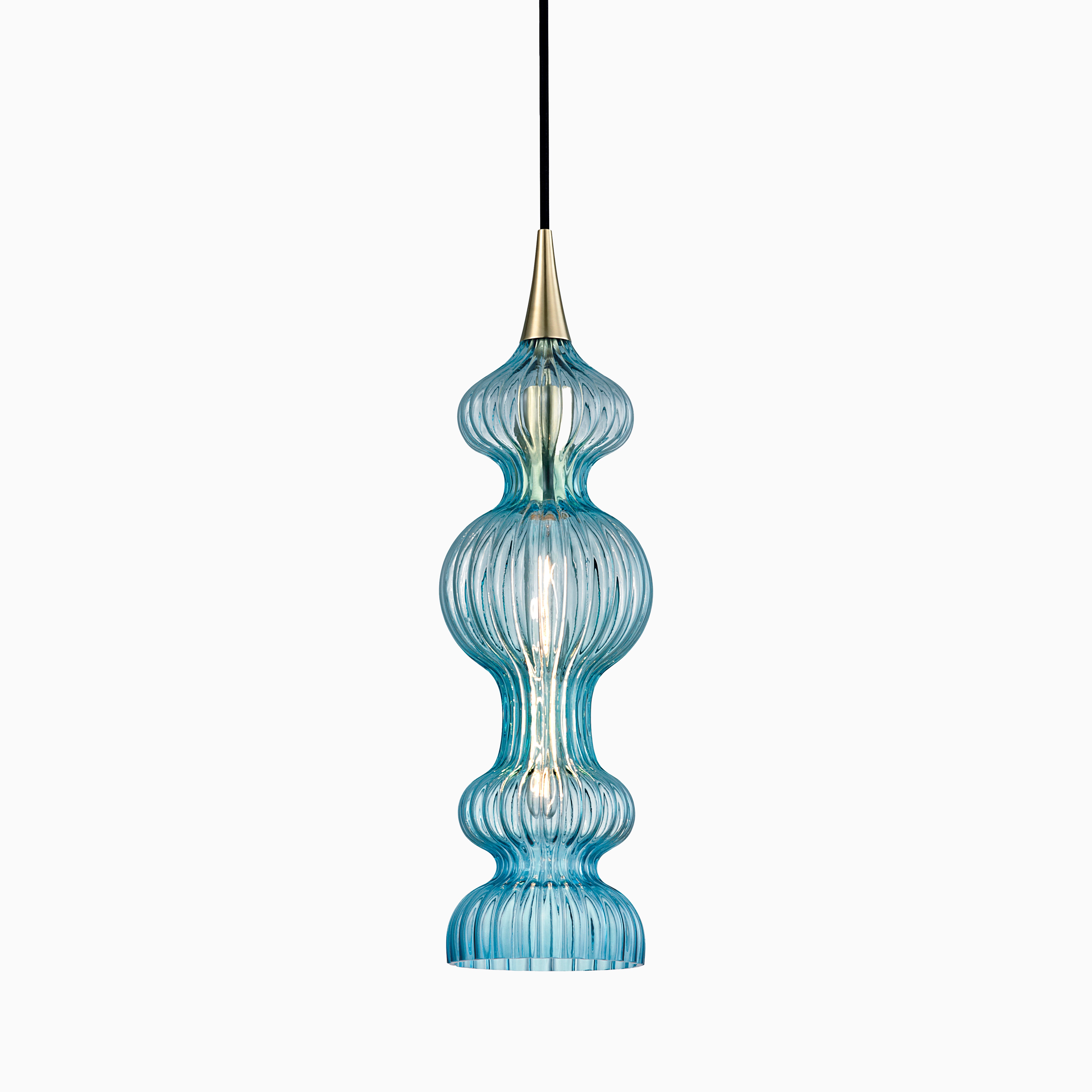 Elongated pendant with rippled blue glass and aged brass accents, casting fluid reflections and vibrant, artistic illumination.