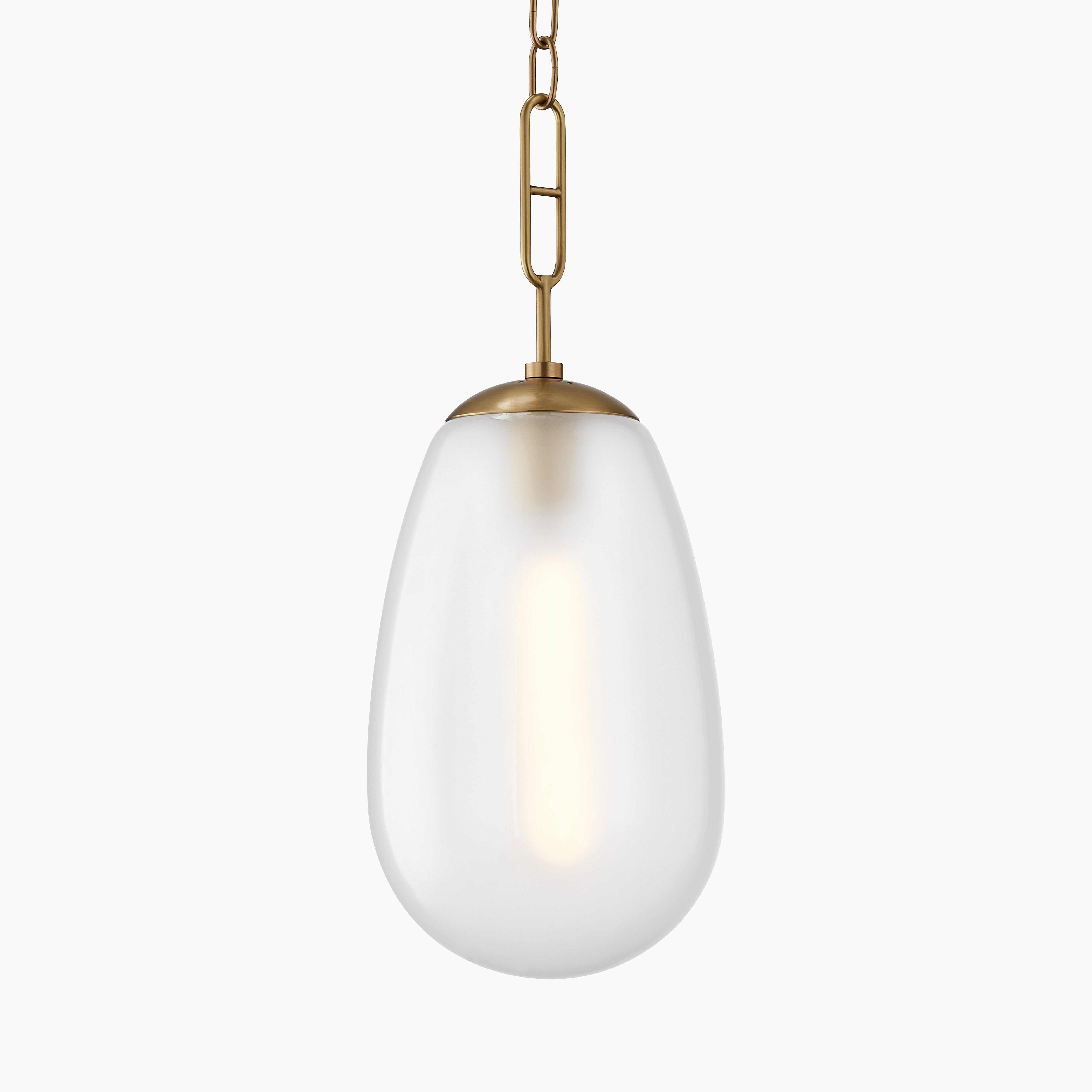 Large teardrop pendant with frosted glass shade and aged brass chain for a soft, modern glow.