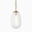 Large teardrop pendant with frosted glass shade and aged brass chain for a soft, modern glow.