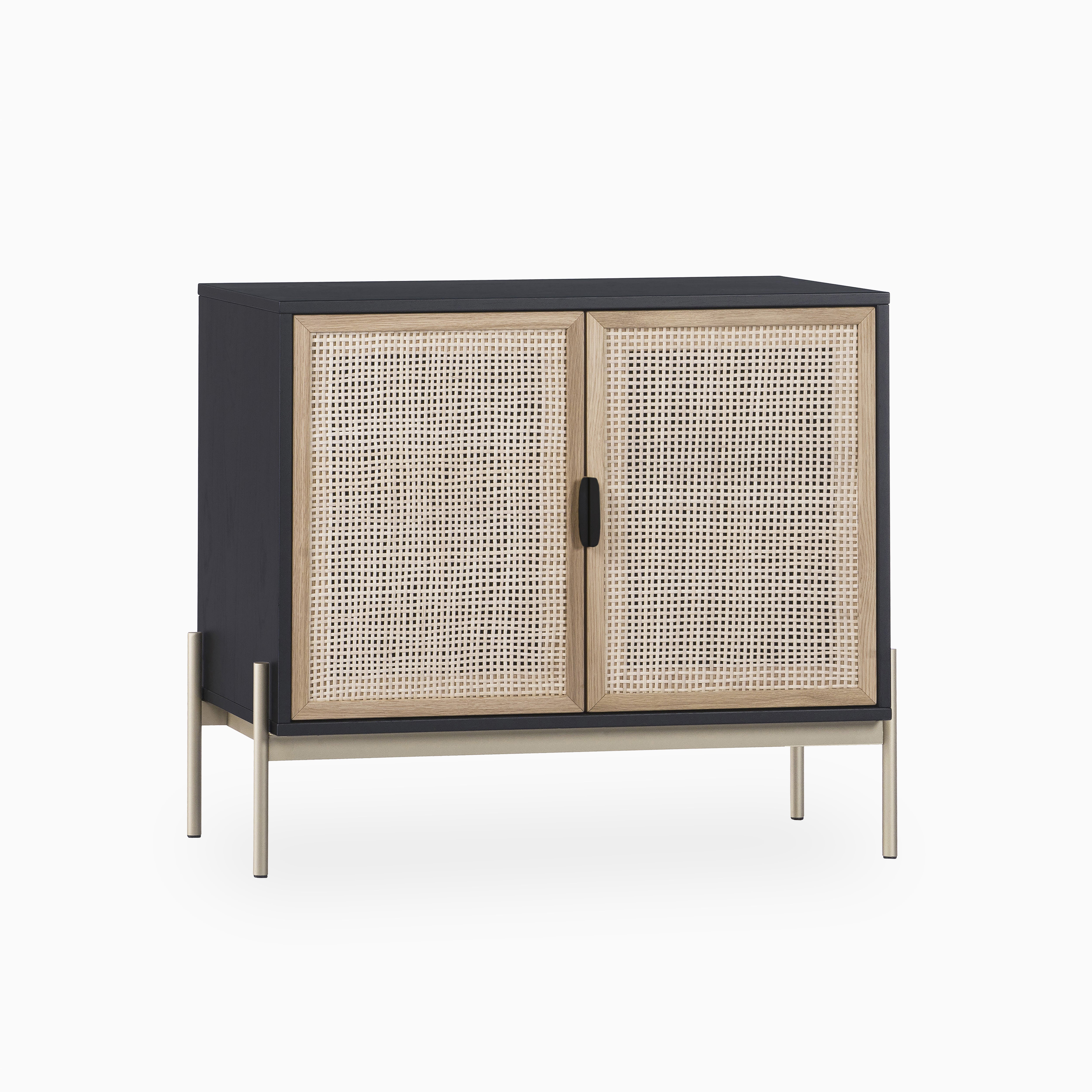 Two-door sideboard featuring a natural cane front, matte black body, and sleek metallic legs blending rustic texture with contemporary design.