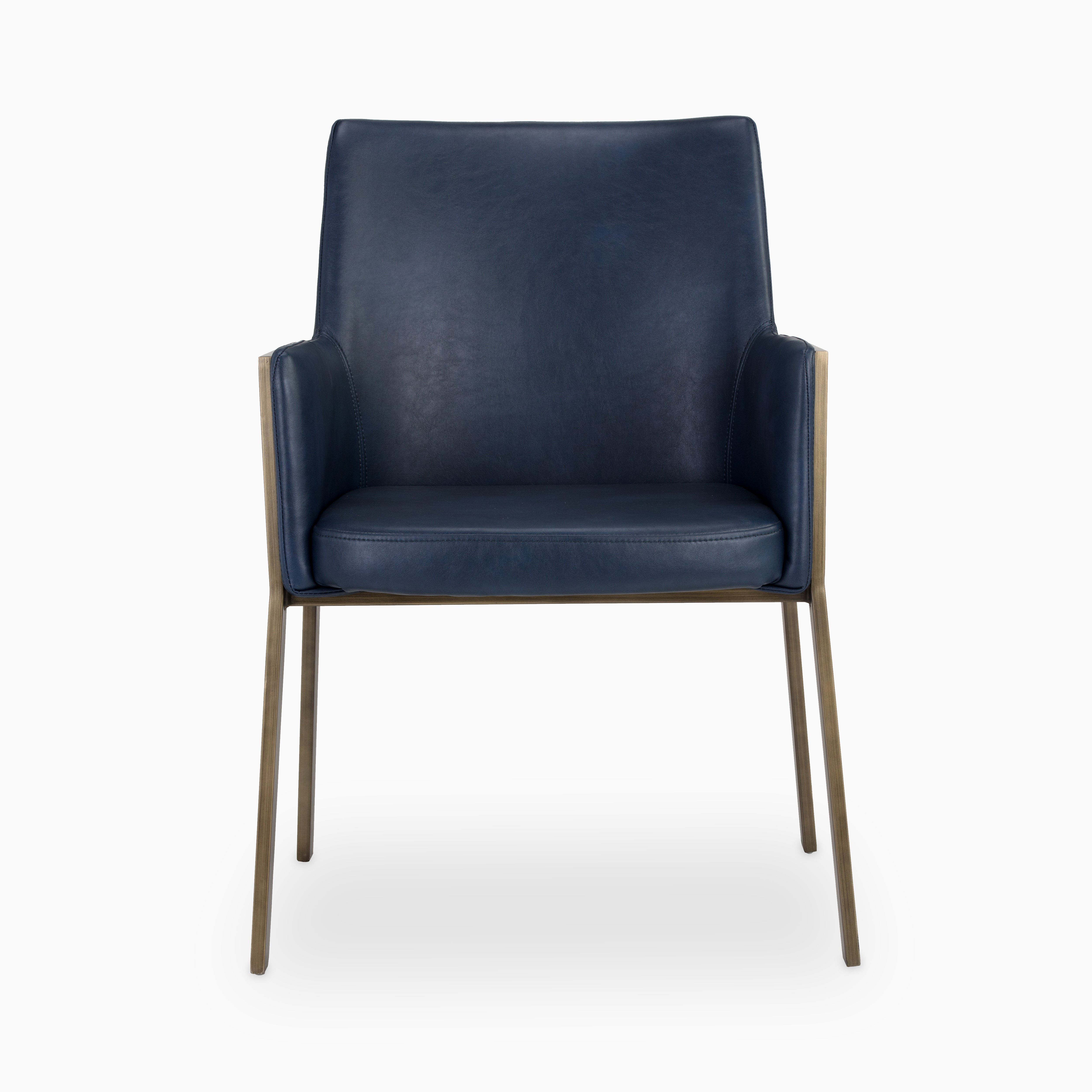 Modern dining chair with navy blue faux leather upholstery and antique brass frame, blending bold color with sleek contemporary design.