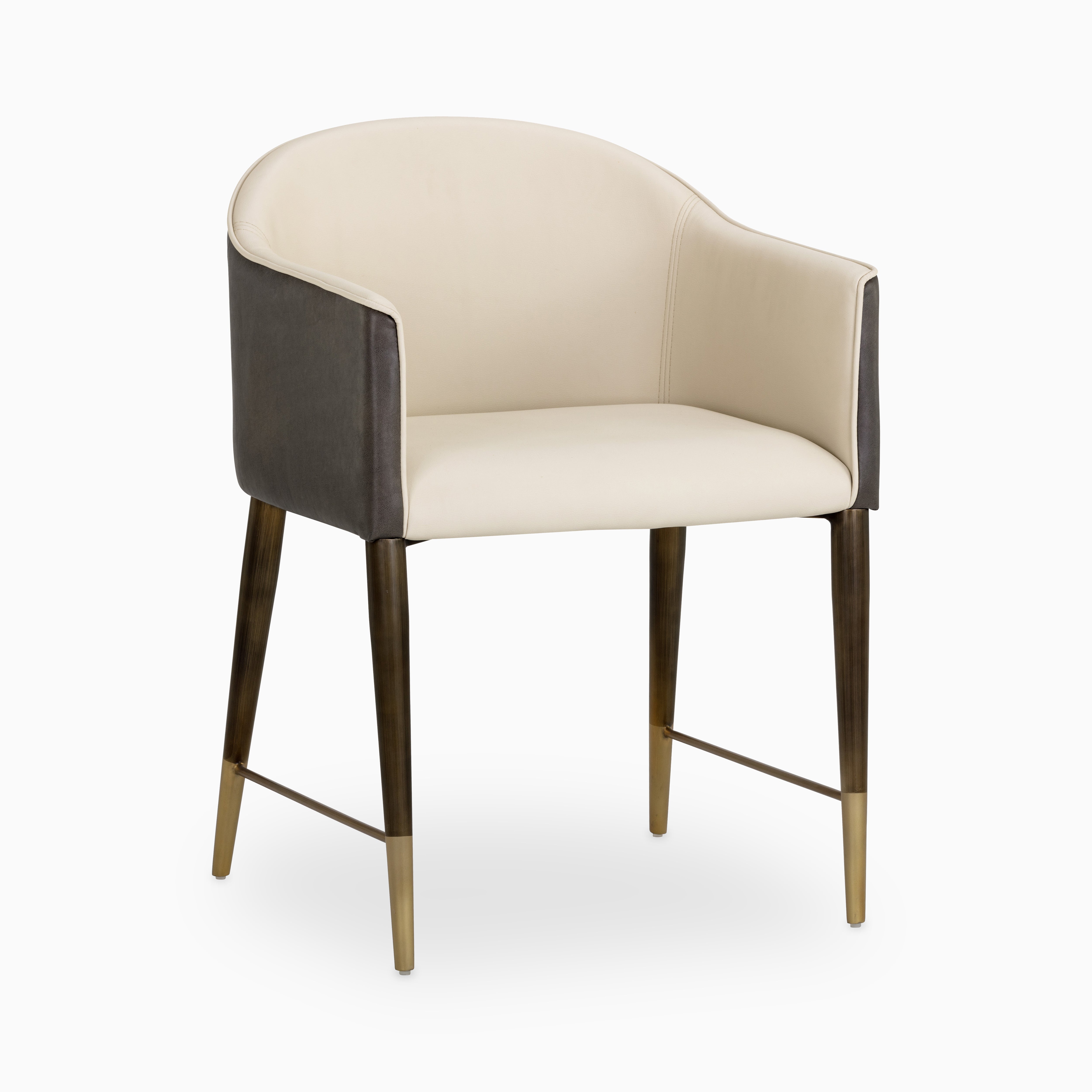 Two-tone barrelback dining chair with cream faux leather interior, dark gray exterior, and champagne gold-tipped metal legs.