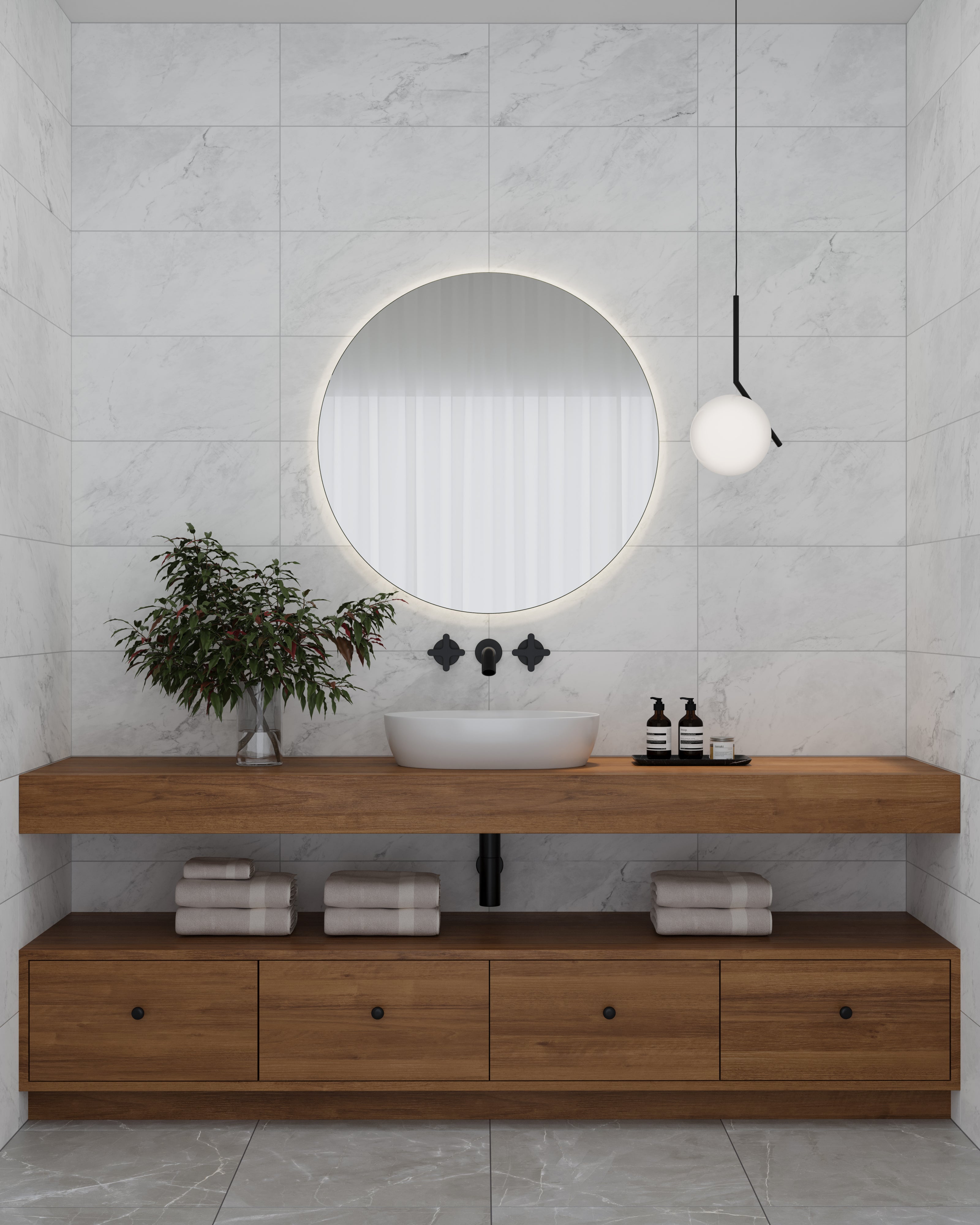 Minimalist bathroom featuring Alaska Glacier matte porcelain tiles with soft marble veining, complemented by a modern wood vanity and round illuminated mirror.