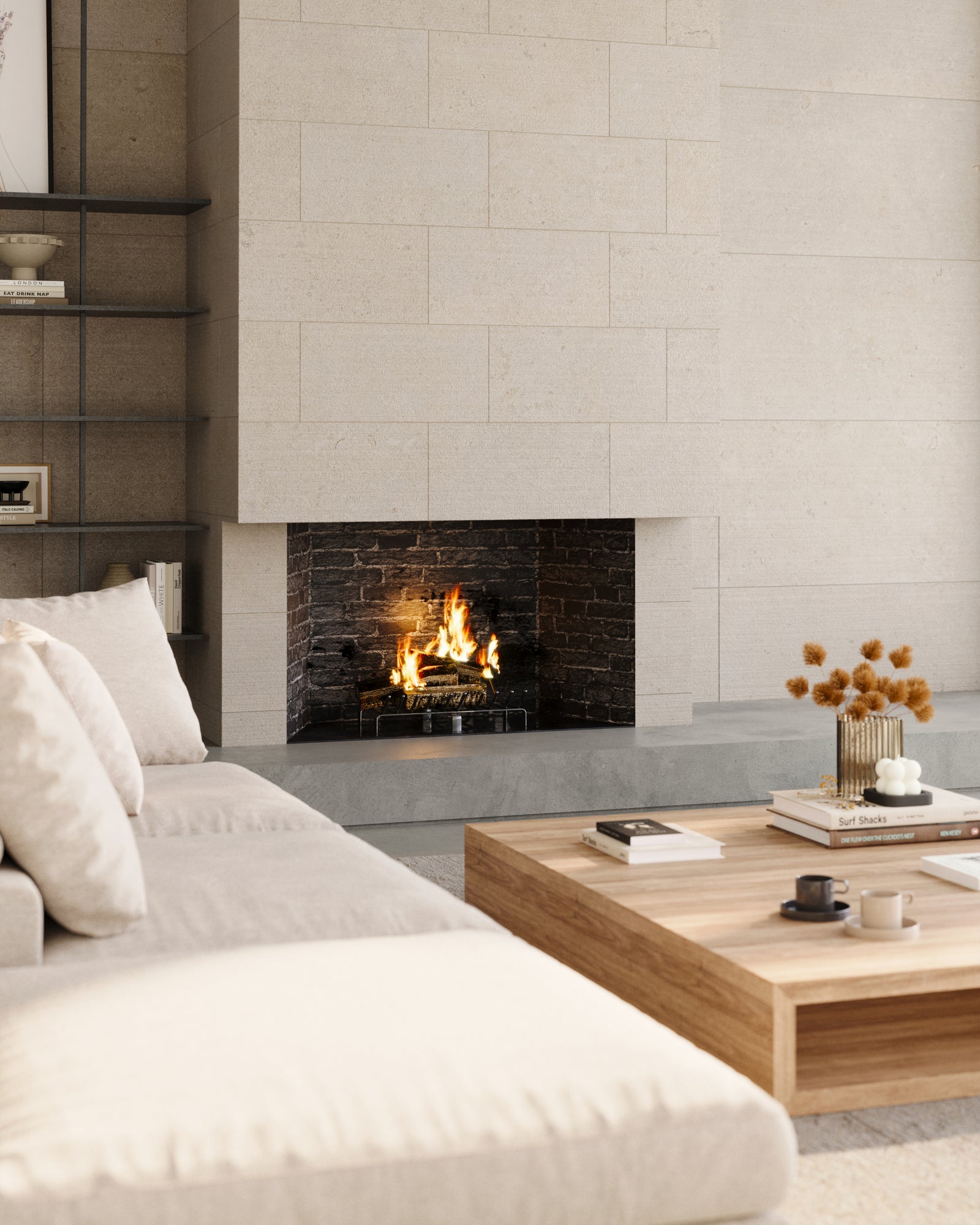 Chiseled Wren 12x24 and 24x48 tiles in dune elegantly cover the living room wall, creating a refined, textured backdrop that enhances the fireplace and complements the minimalist decor.