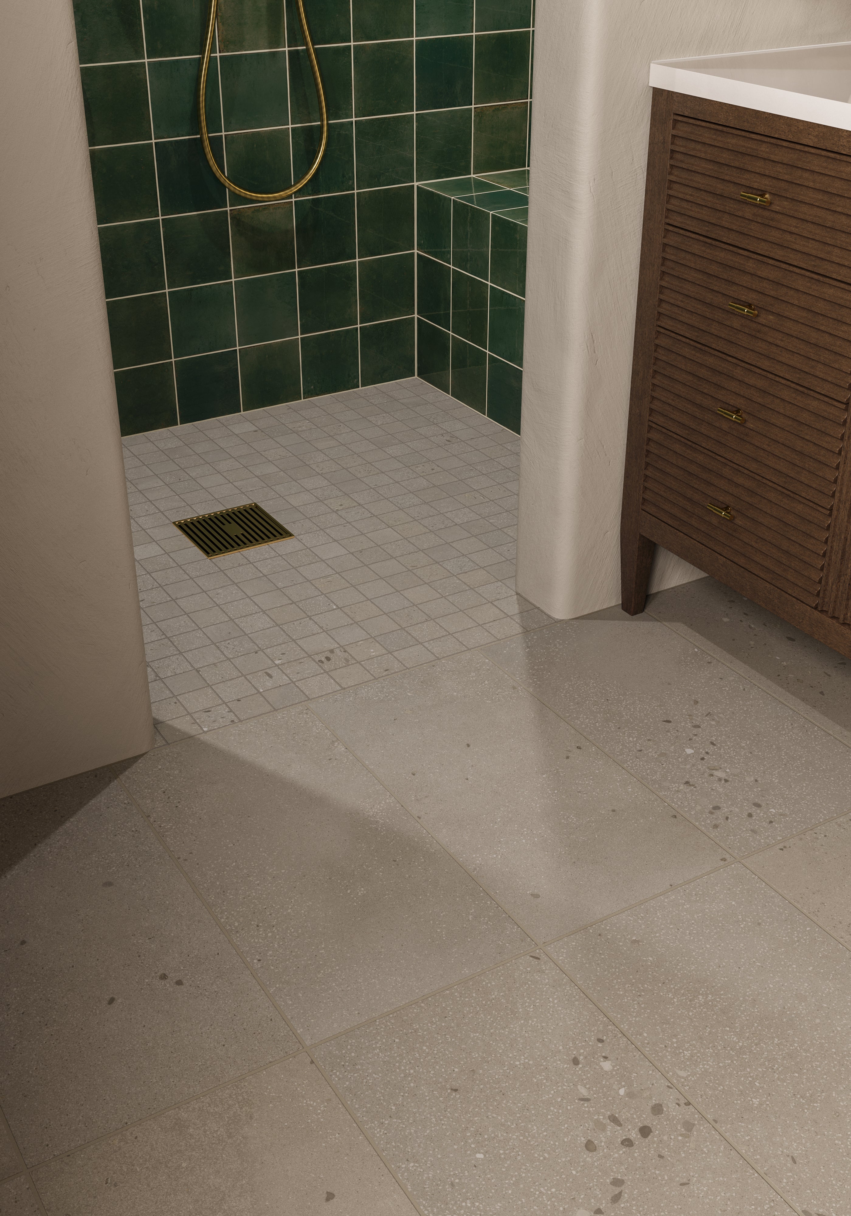 Bathroom floor with light gray tiles leading into a shower lined with rustic dark green porcelain tiles.