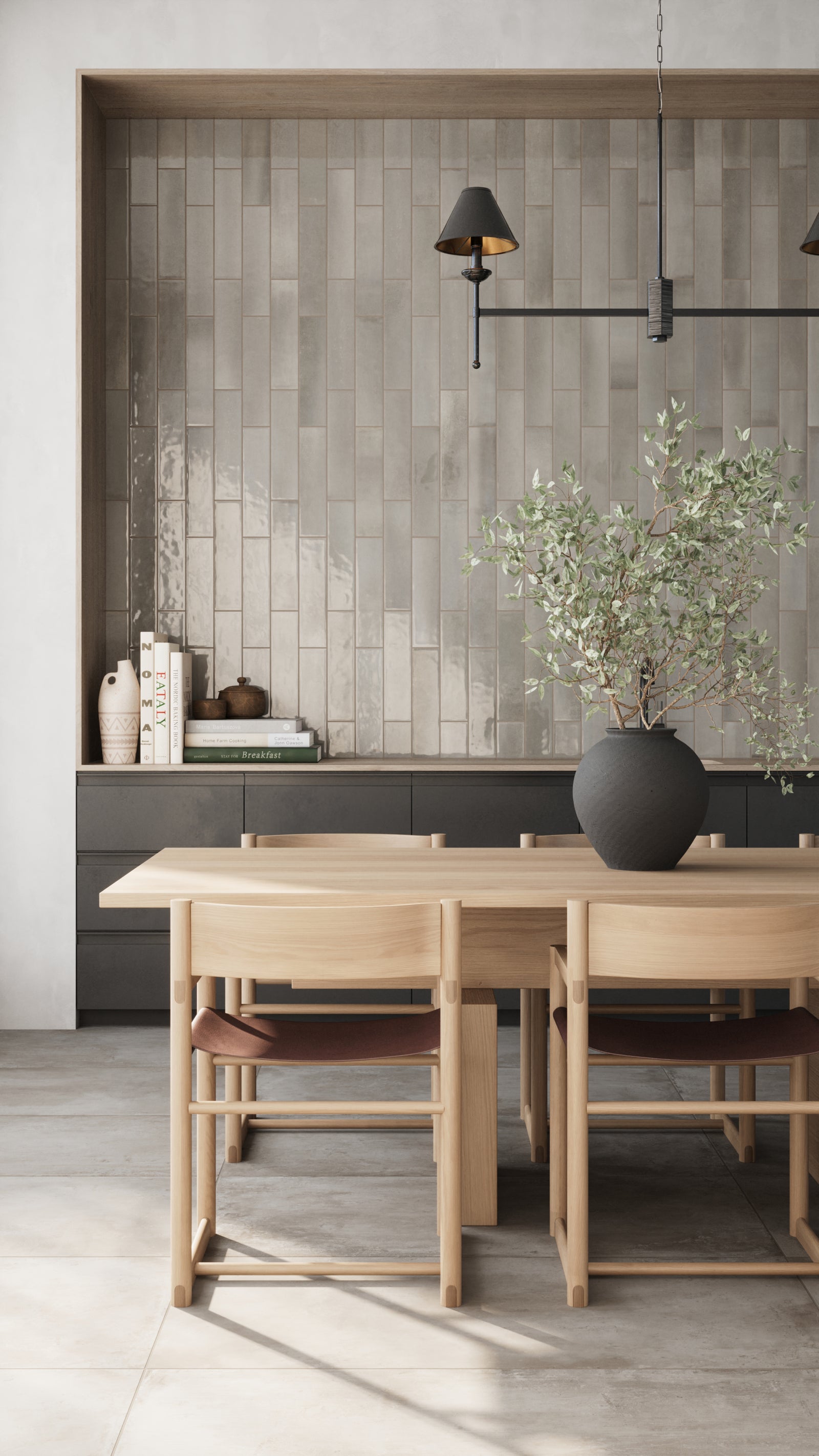 Taupe glossy subway tiles create a stunning accent wall, complementing natural wood furniture and modern black lighting in a serene dining space.