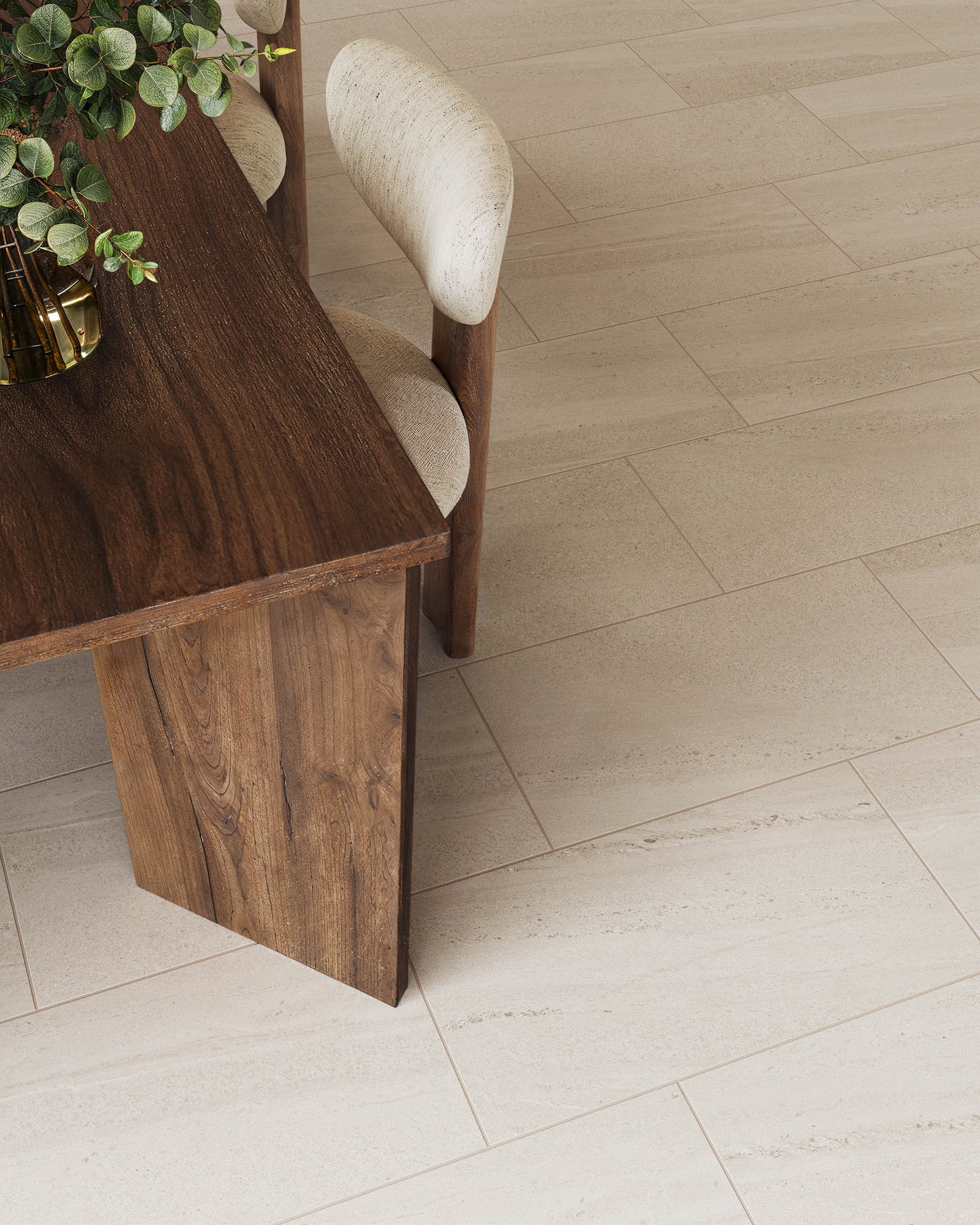Detail shot of Bryce Dune satin tile flooring in beige, complementing a natural wood table and soft-textured dining chairs.