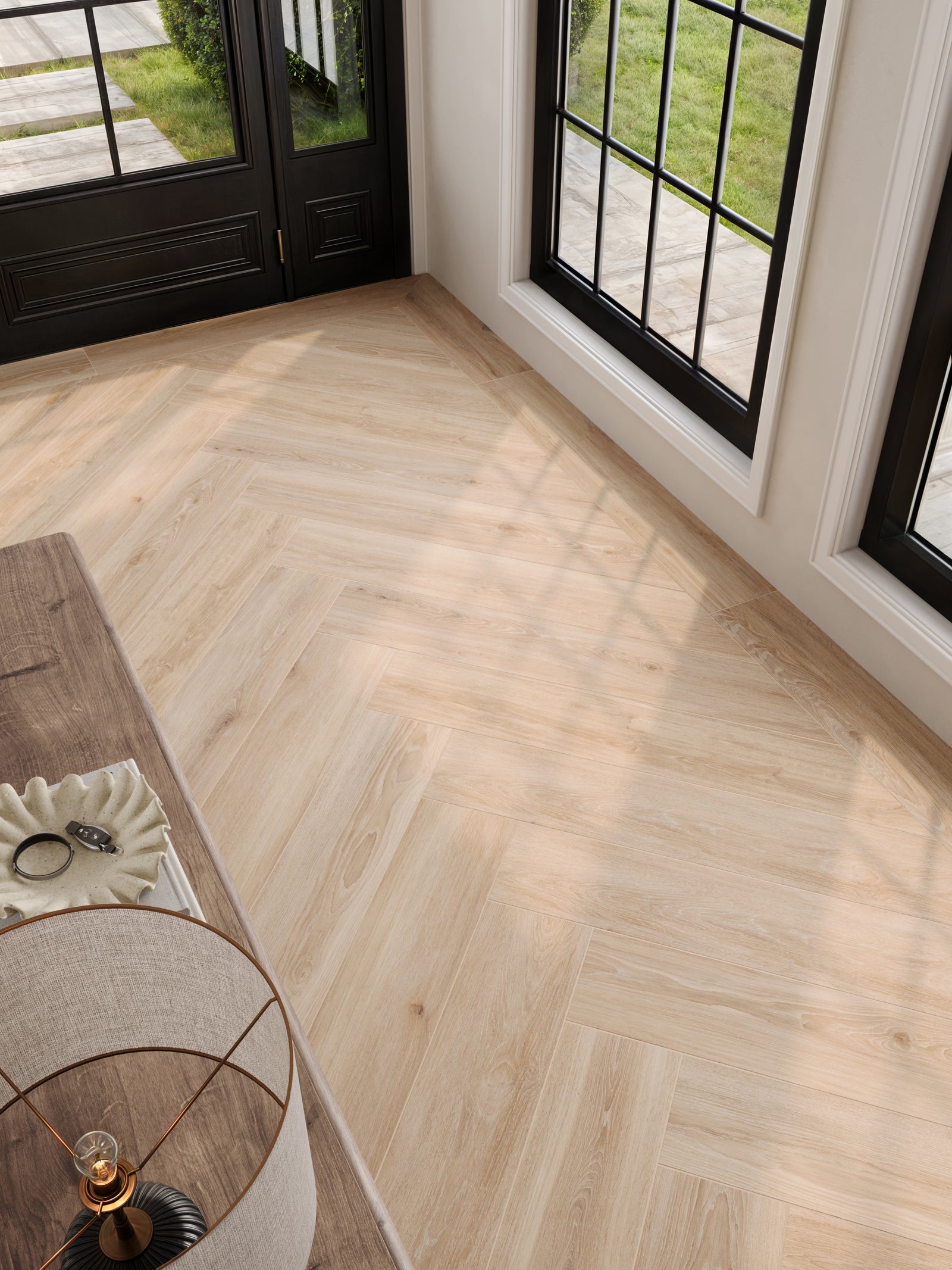 Close-up of Jameson 8x48 matte porcelain tile in Camel, laid in a refined herringbone pattern, showcasing its warm, natural wood-look finish.