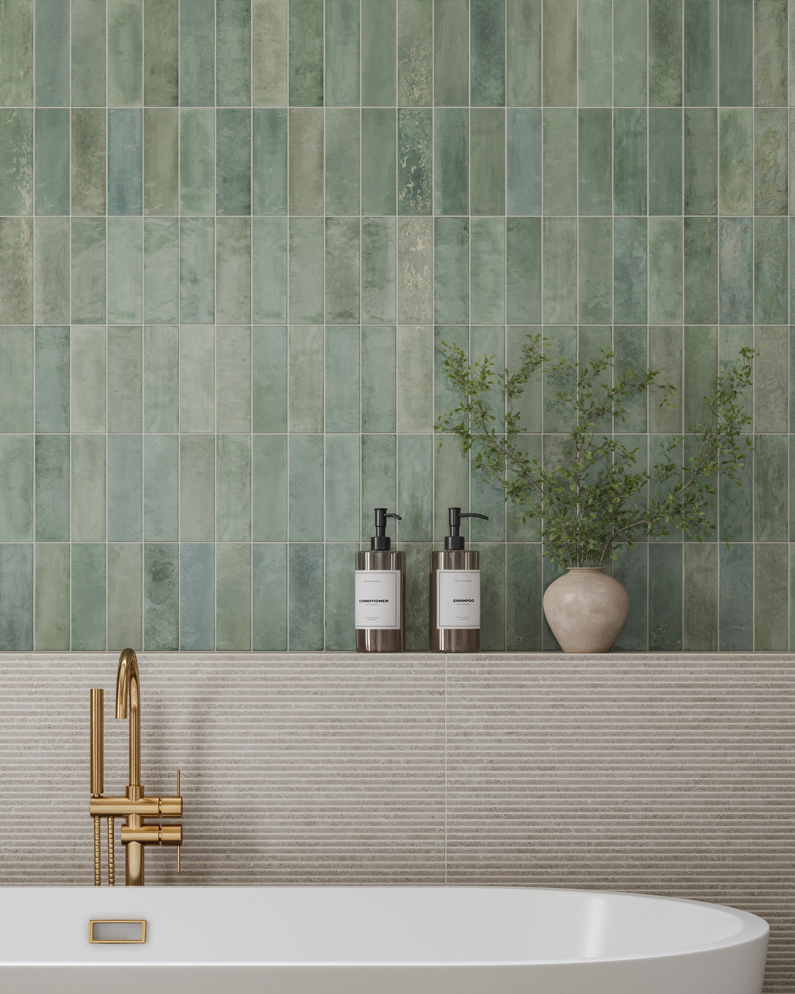 Bathroom wall with glossy green subway tiles in shifting tones above a textured beige backsplash, featuring a white bathtub, gold faucet, and countertop with soap dispensers and a small potted plant