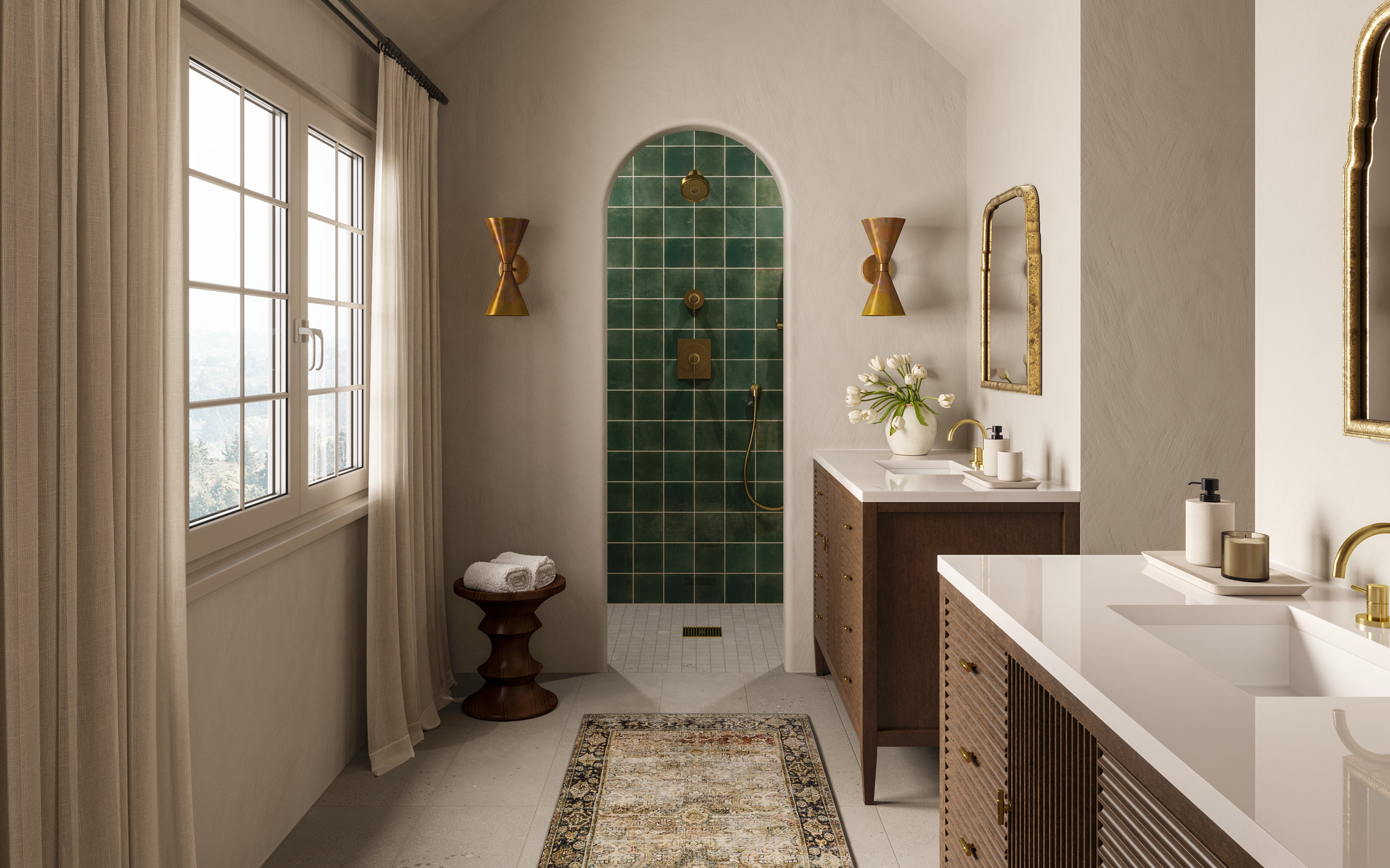 Vanity and mirror set beside a walk-in shower lined with rustic dark green porcelain tiles, highlighted by warm gold fixtures.