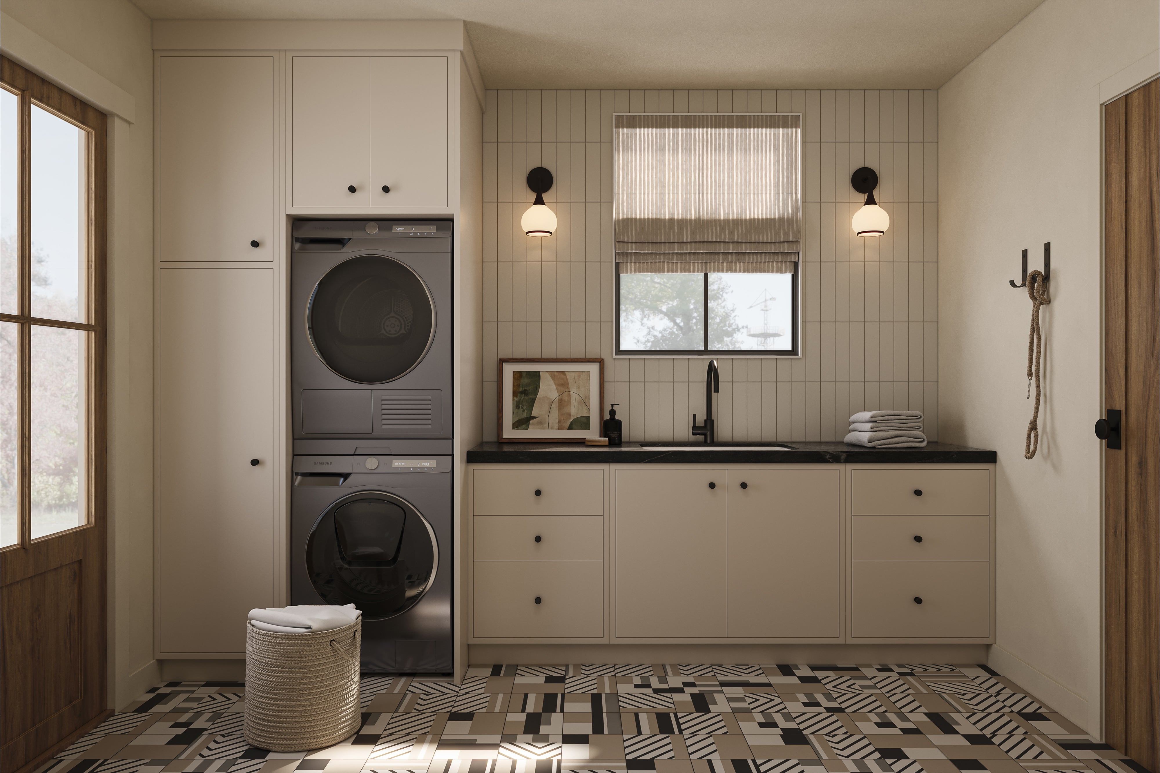 Modern laundry room with stacked washer and dryer, beige cabinetry, black countertop sink, patterned tile floor, and two matte black wall sconces beside a window with a Roman shade.
