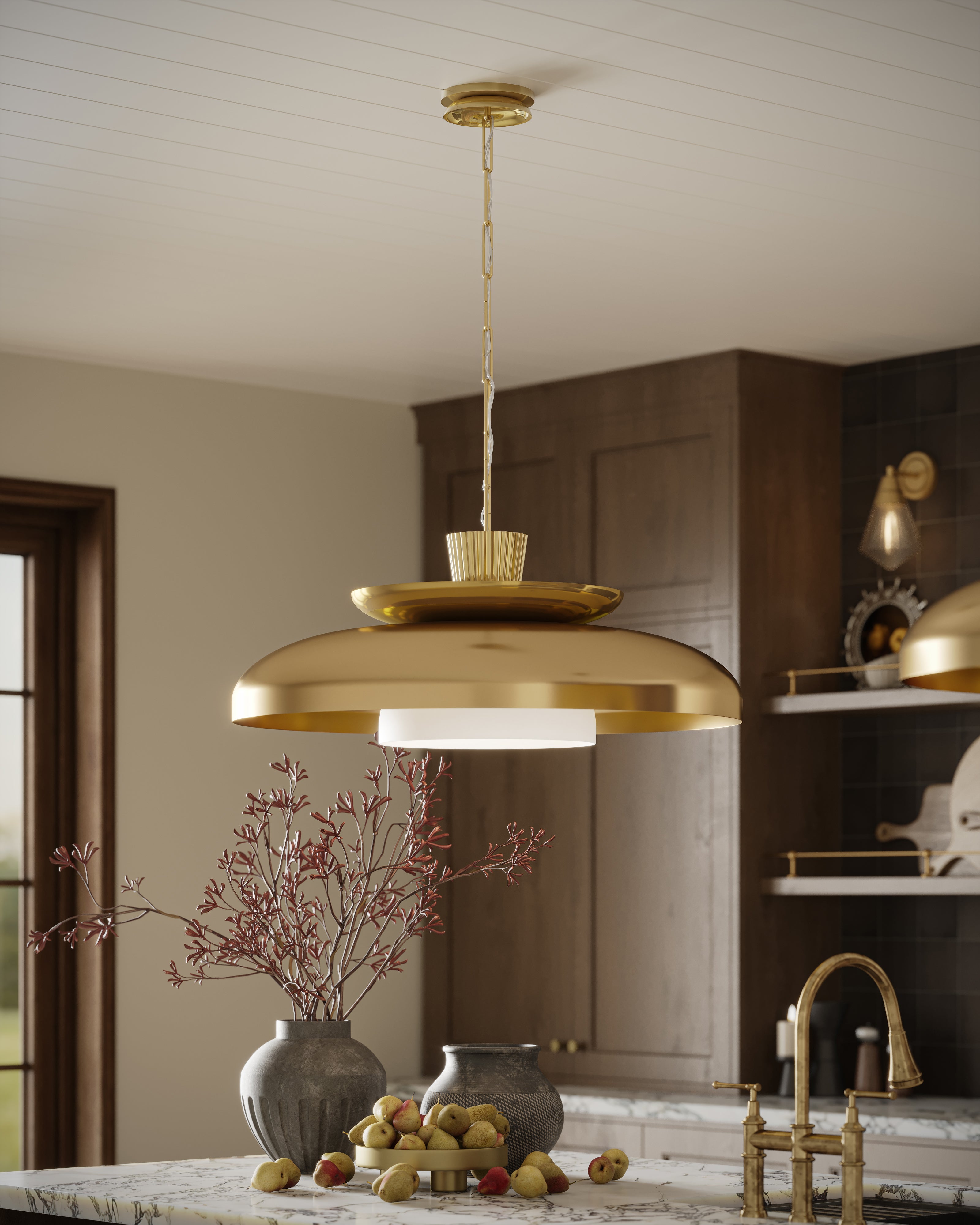 Vintage brass pendant light with a wide reflective dome shade and a frosted diffuser, suspended by a brass chain over a marble kitchen island for warm, modern illumination.