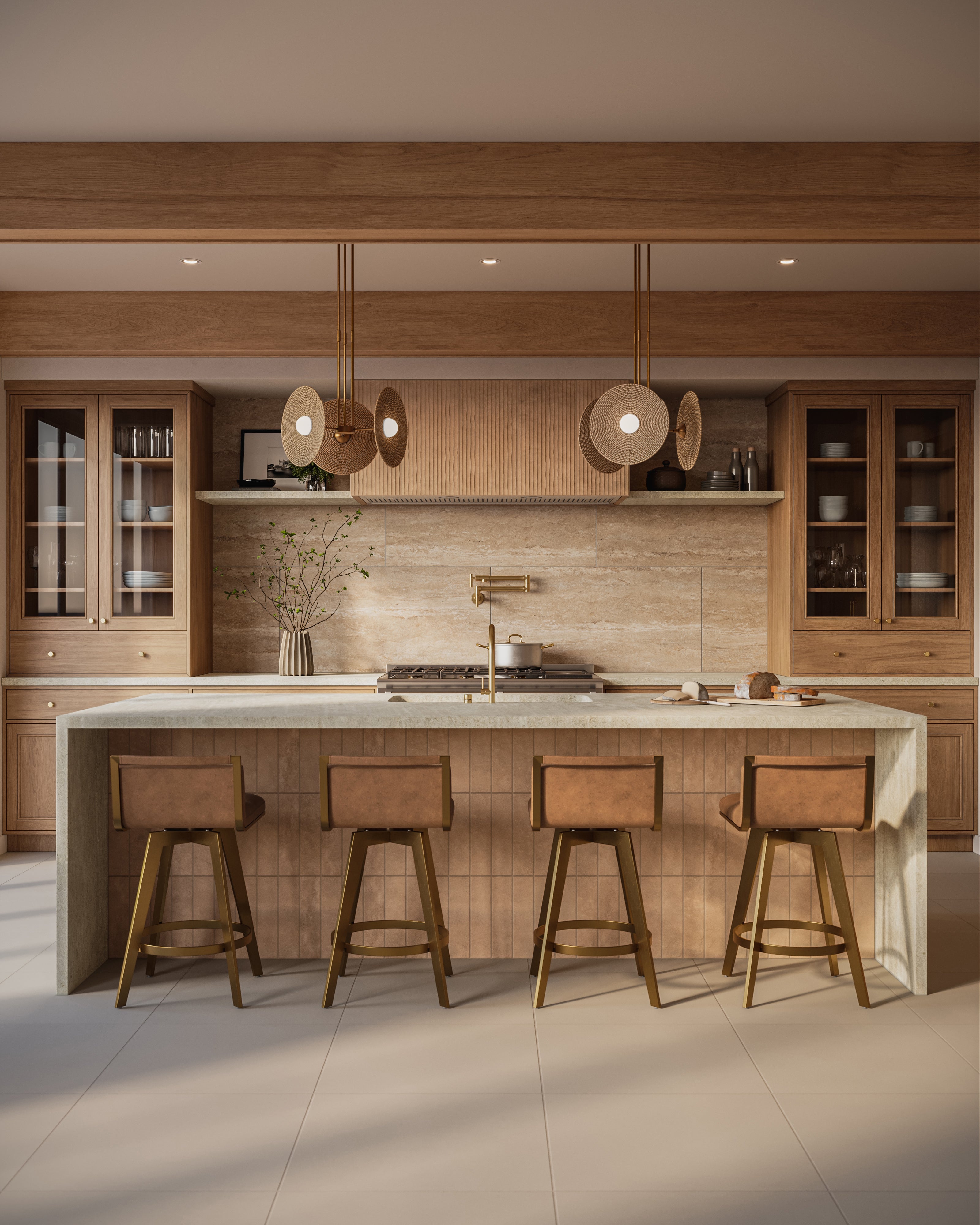 Vintage brass pendant lights with woven rattan shades above a large beige stone kitchen island with four brass bar stools.