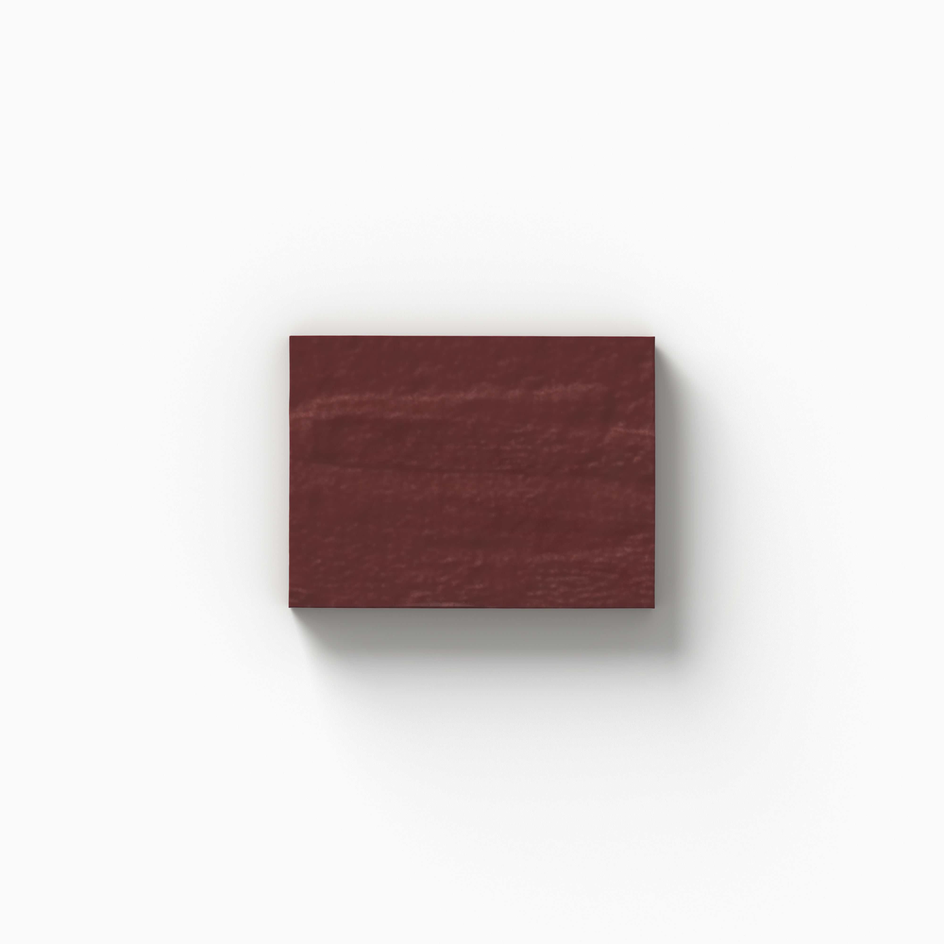 An earthy red 3x4 porcelain tile sample with a glossy finish, showcasing gentle color movement and handcrafted character on a white backdrop.