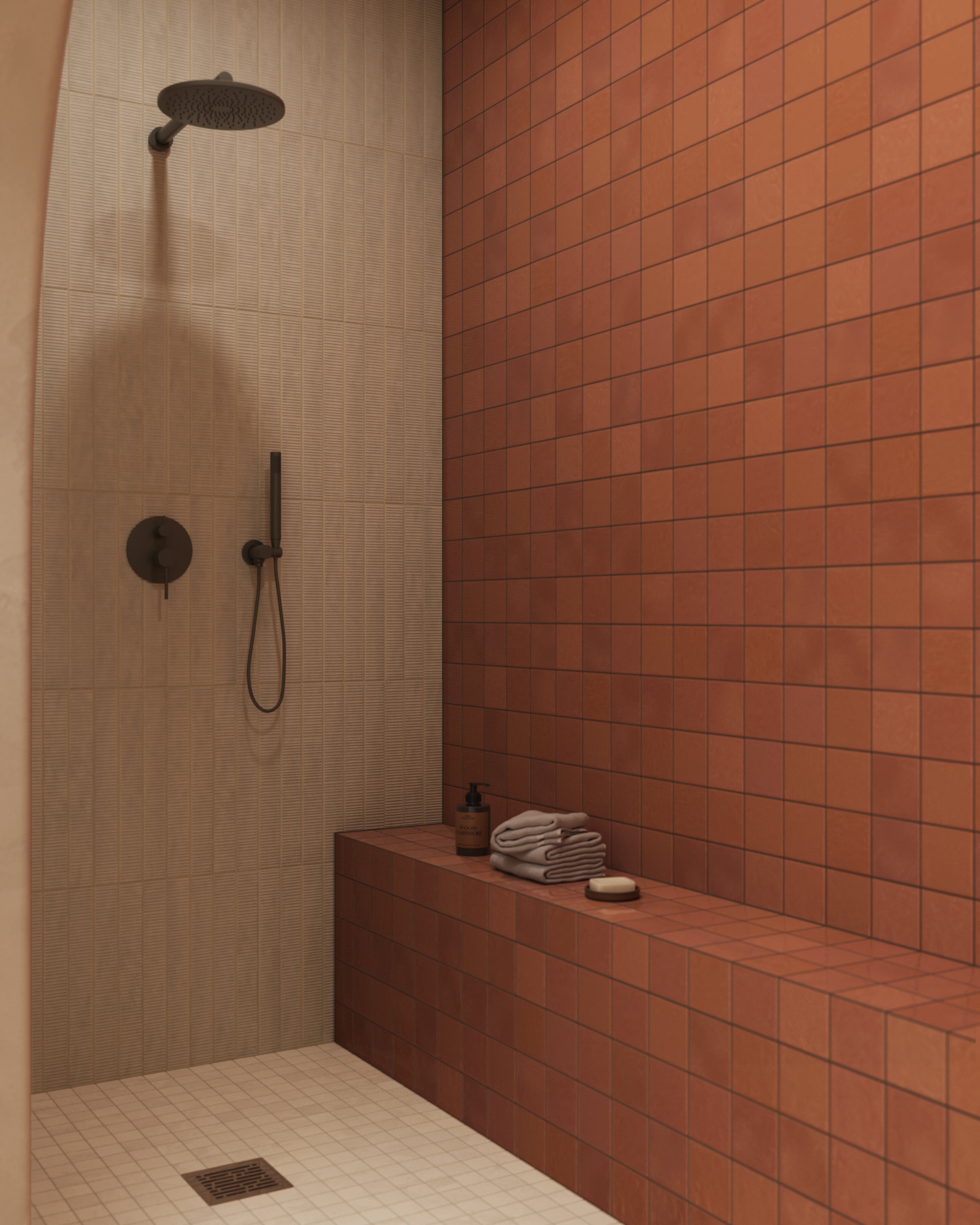 Spa-style bathroom with an arched shower opening, glossy rust square tile on the shower wall and bench, cream floor tile, beige plaster walls, natural wood accents, and soft skylight illumination.