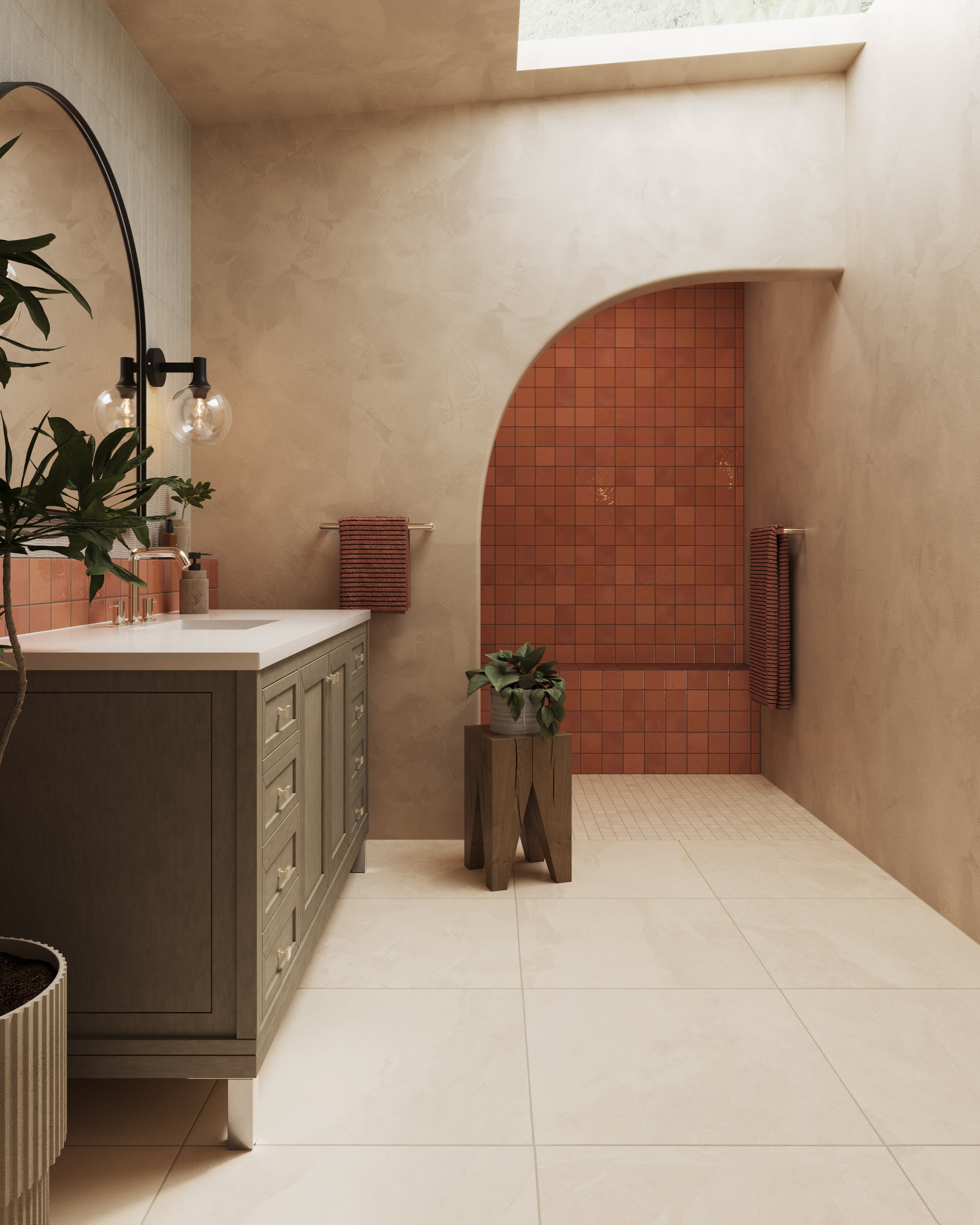 Walk-in shower with glossy rust square tile covering the feature wall and bench, contrasted by cream reeded tile on the side wall, small beige floor mosaics, and matte black shower fixtures.