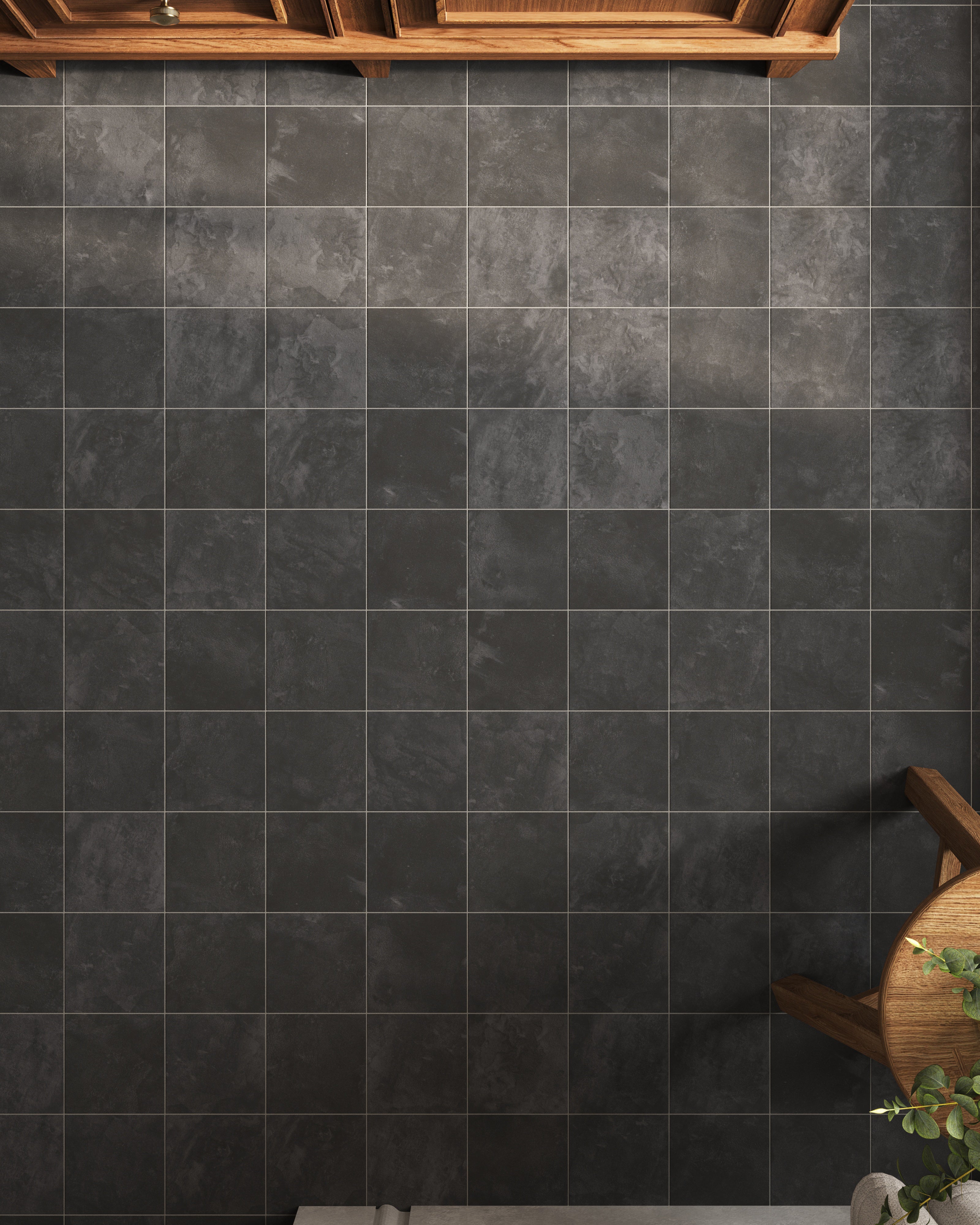 Matte dark gray porcelain tiles with subtle stone movement form a calm, structured floor pattern, giving this bathroom a grounded feel that pairs easily with natural wood elements.