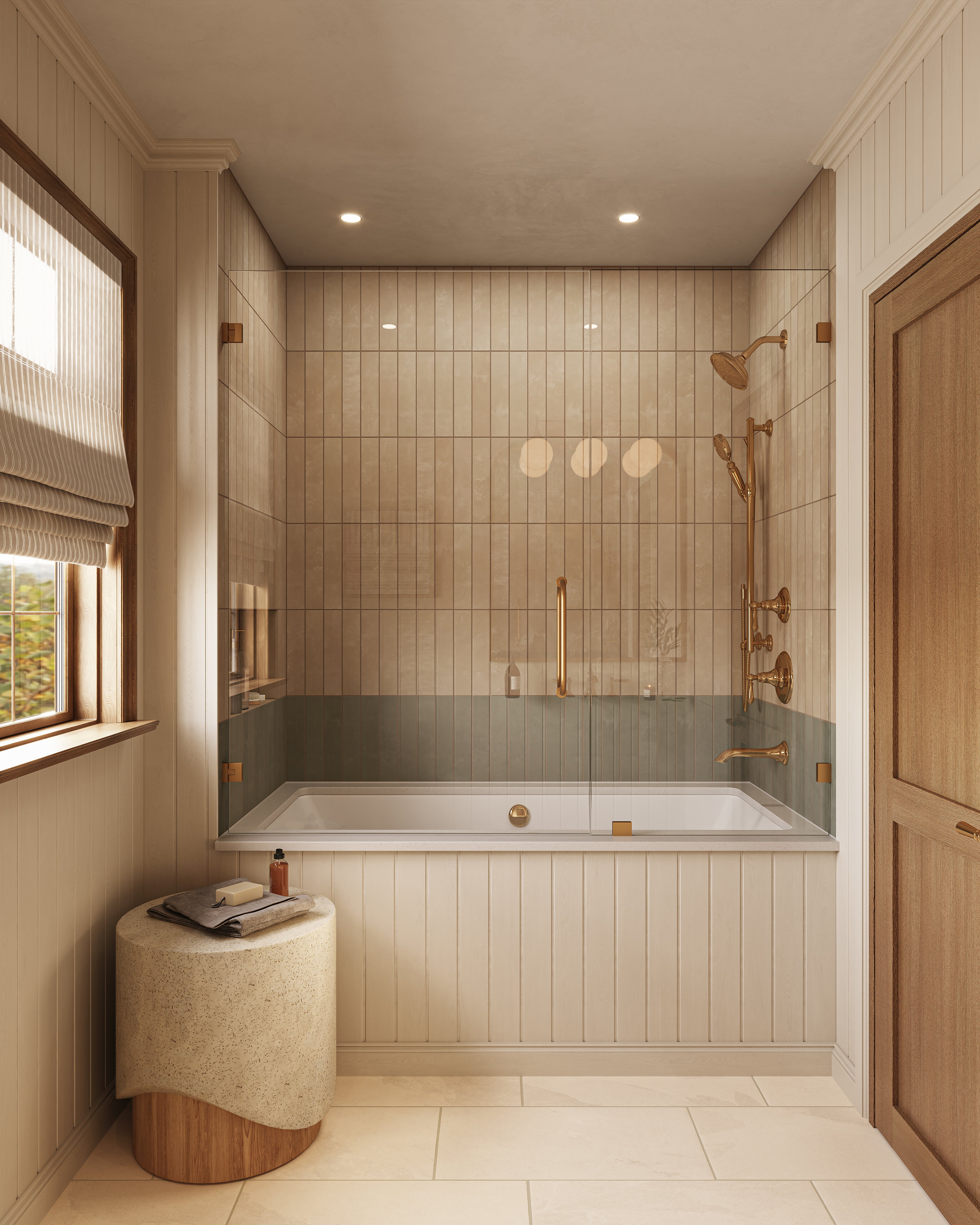 The tub area is wrapped in muted sage green porcelain subway tiles, adding a quiet wash of color that works easily with brass fixtures and light wood tones.