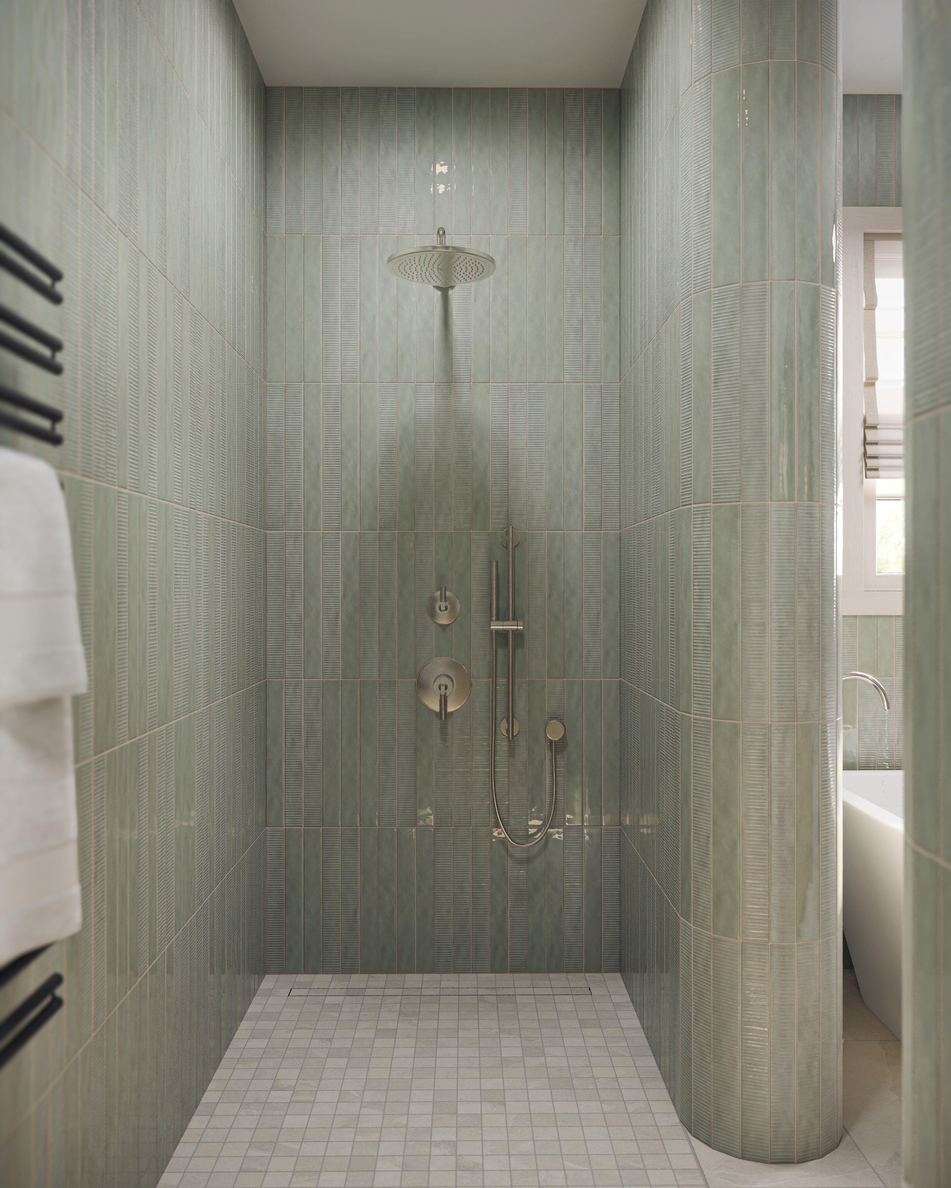 Walk-in shower with glossy pale green vertical wall tiles, rainfall showerhead, handheld shower fixture, and small white mosaic floor tiles.