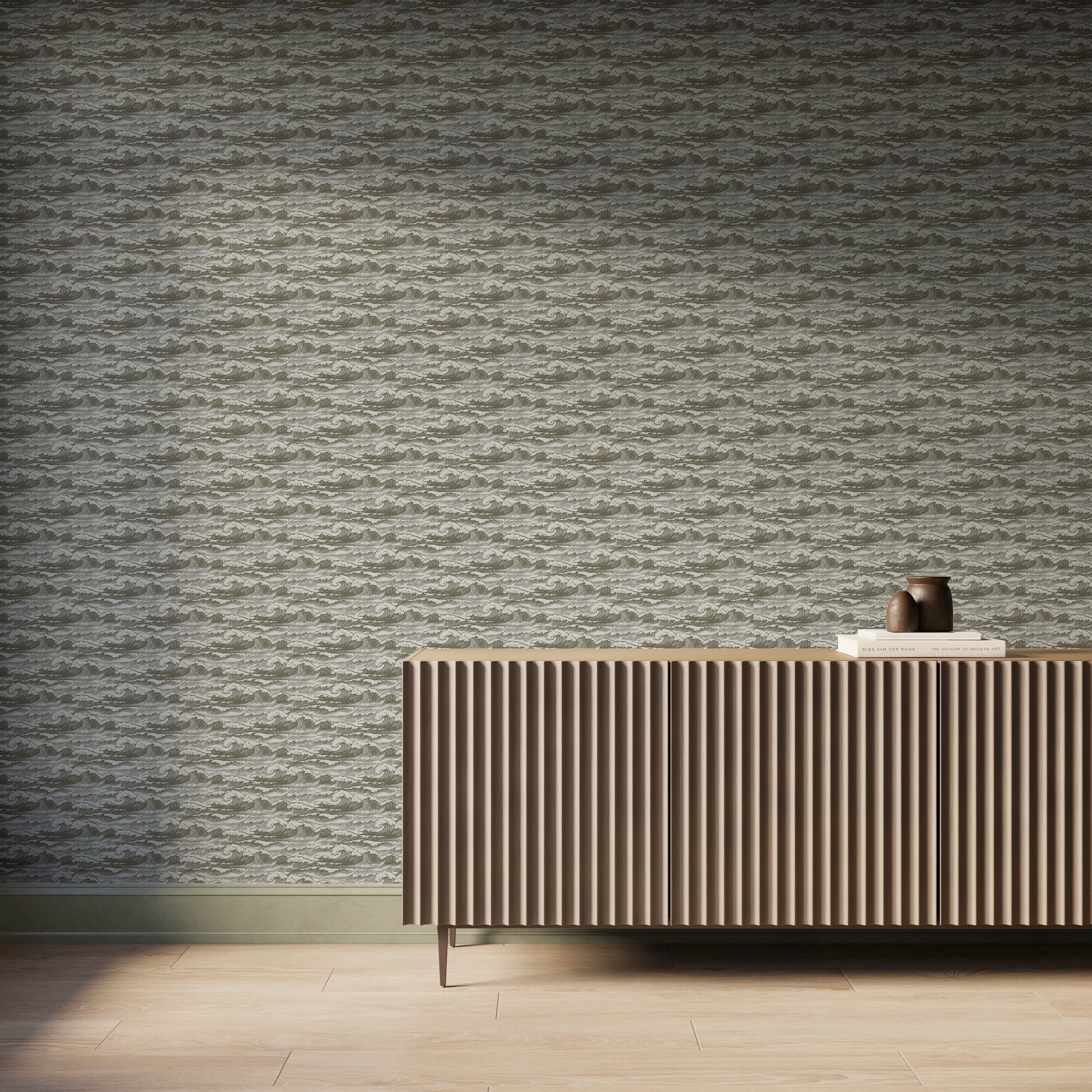 Olive wave-pattern wallpaper behind a modern ribbed wood sideboard with books and pottery in a warm coastal-inspired room.