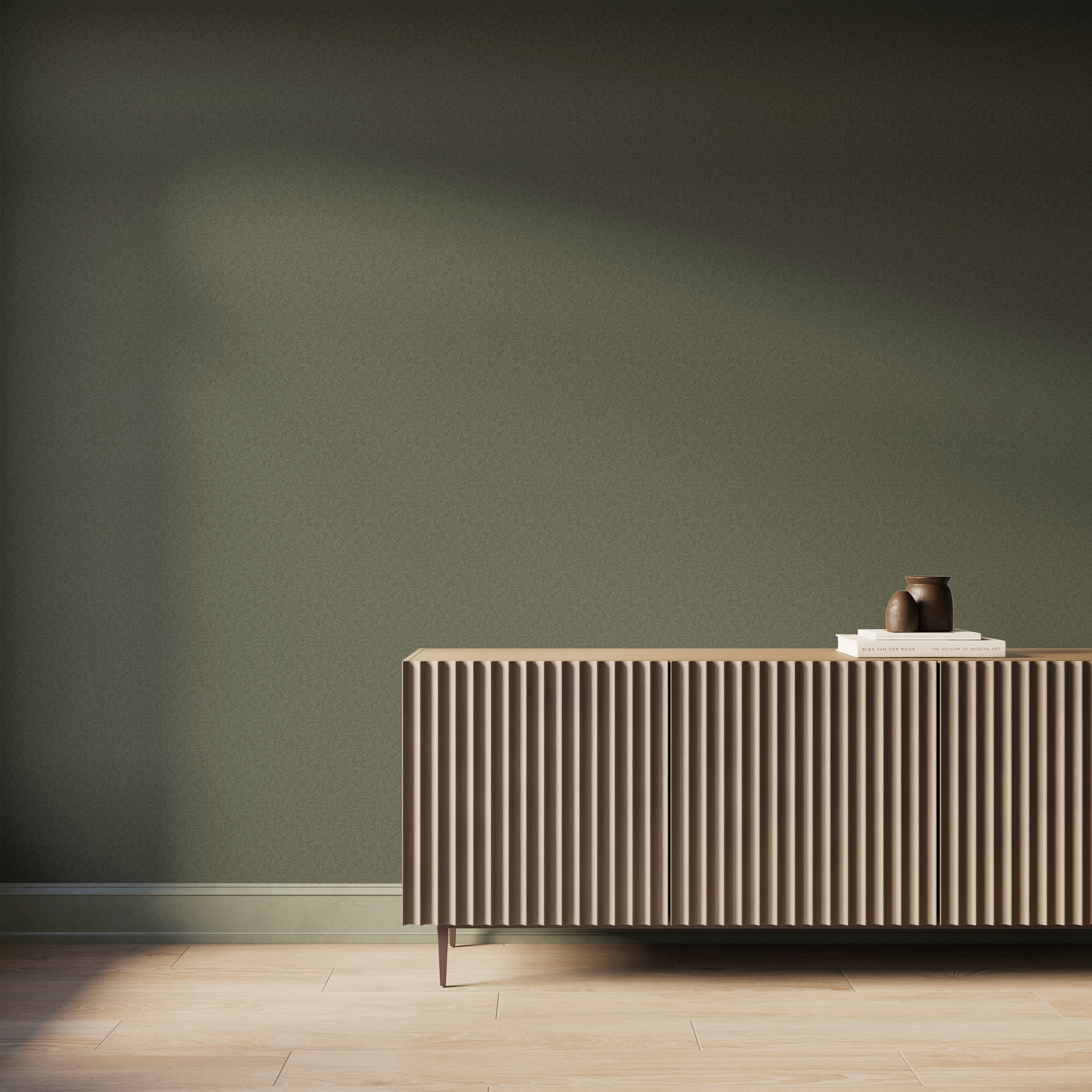 Modern interior featuring olive green botanical wallpaper with a subtle hand-sketched texture, paired with a fluted wood console cabinet, light wood flooring, and soft natural light casting gentle shadows across the wall.