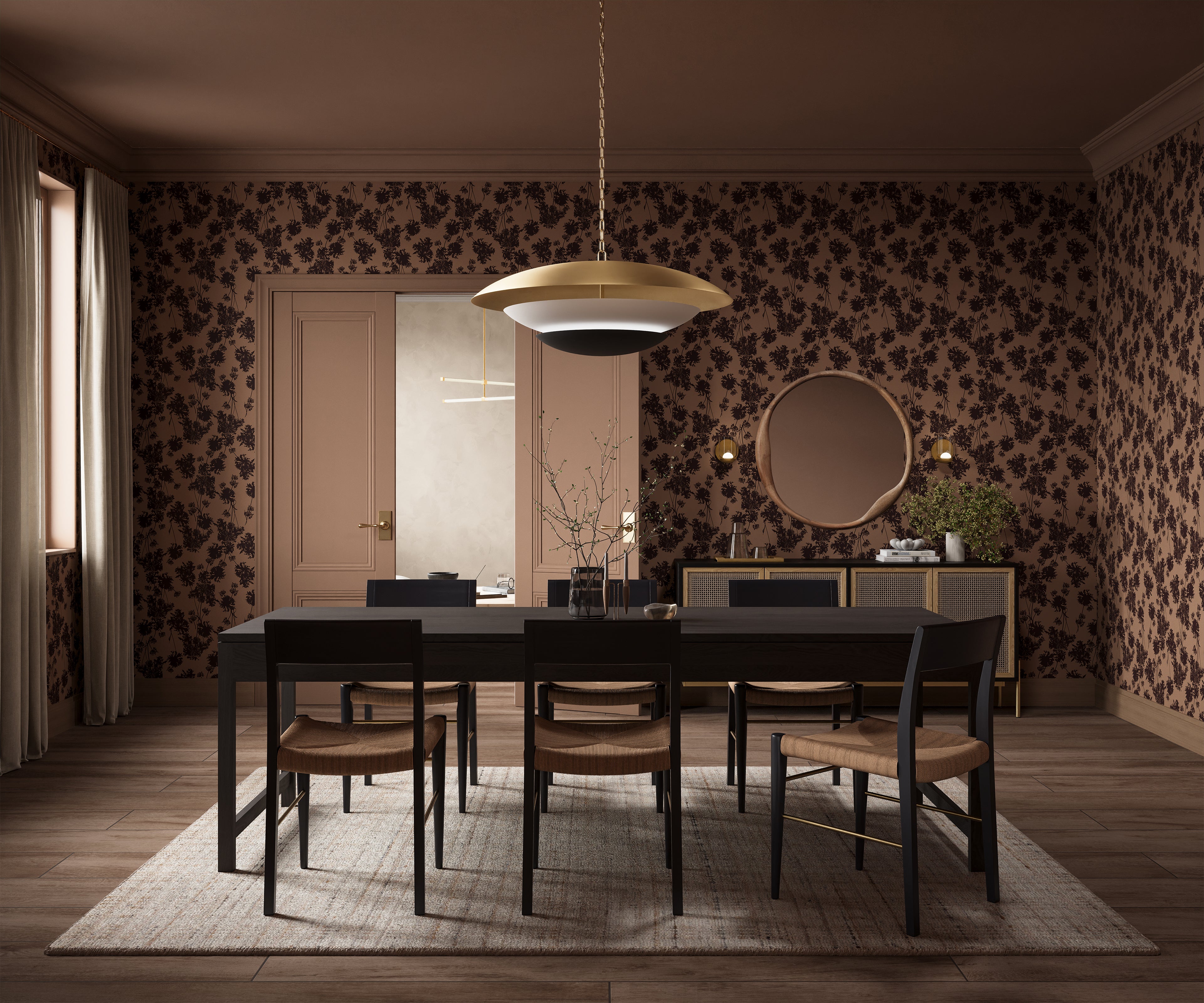 Dining room with dark floral wallpaper, wood table and chairs, pendant light, and cabinet with round mirror and plants.