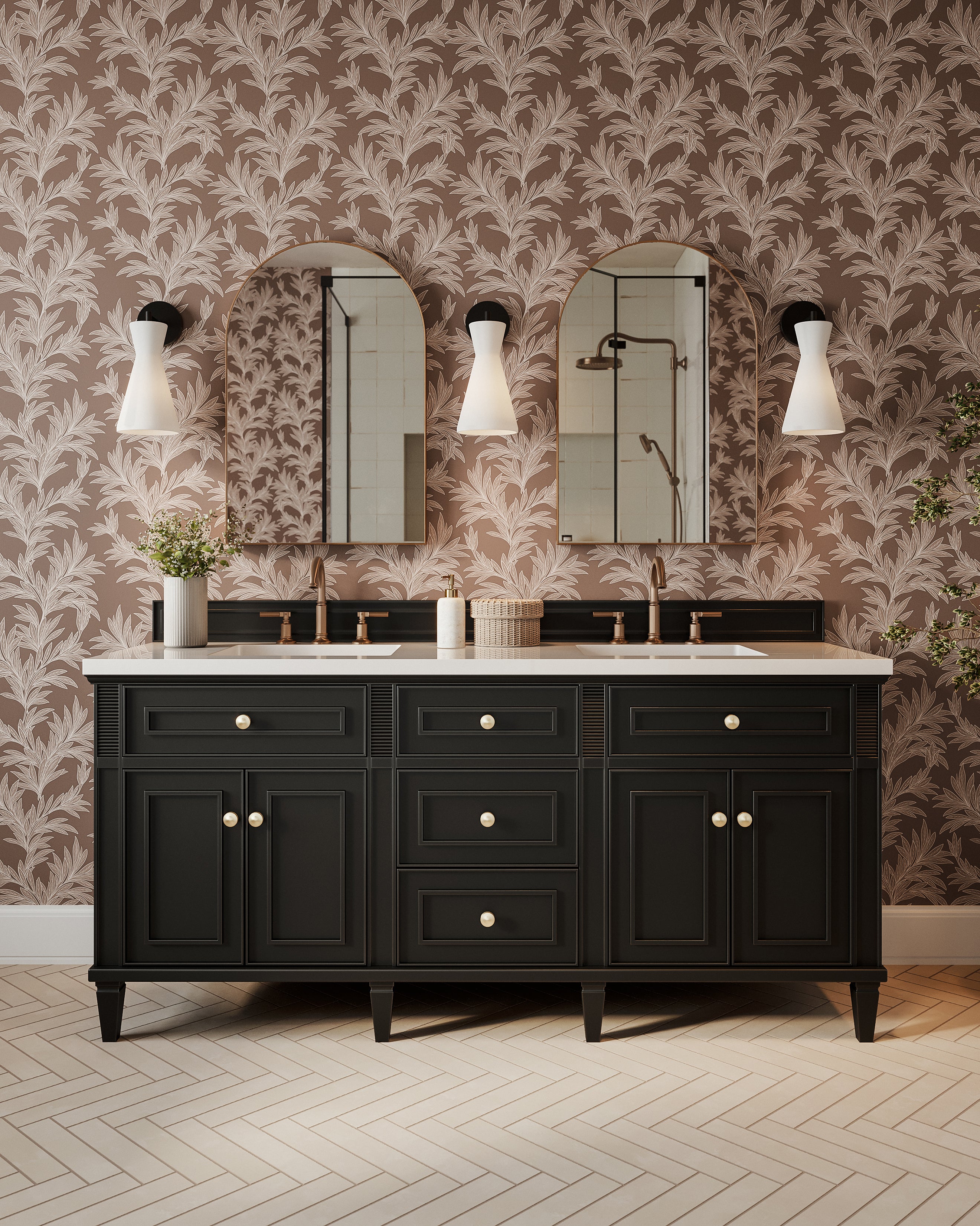 Modern double vanity with black cabinetry, brass faucets, arched mirrors, botanical wallpaper, white wall sconces, and subway tile flooring in herringbone pattern.