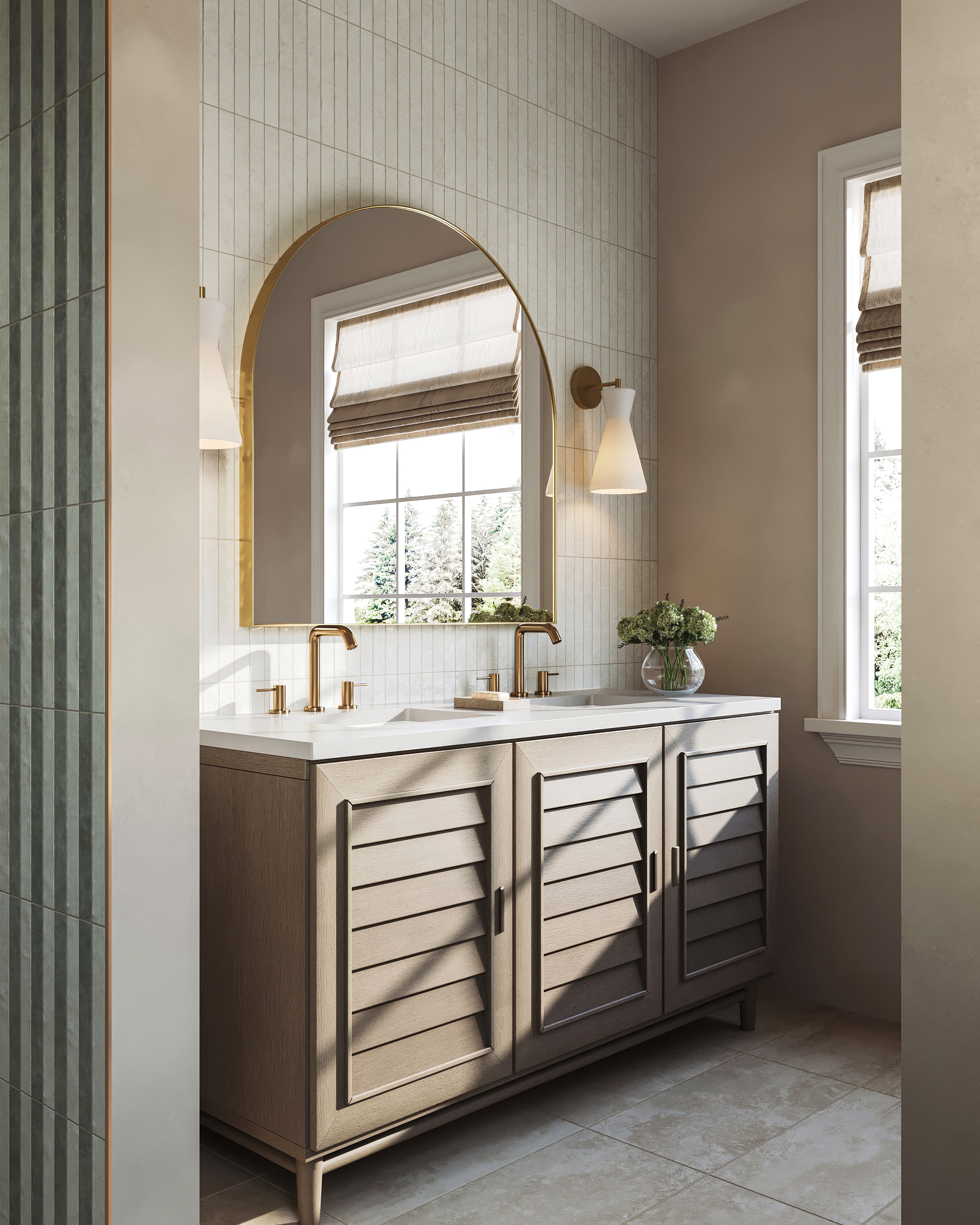 Modern bathroom vanity with wood cabinetry, brass faucets, arched mirror, wall sconces, and vertical subway tile backsplash.