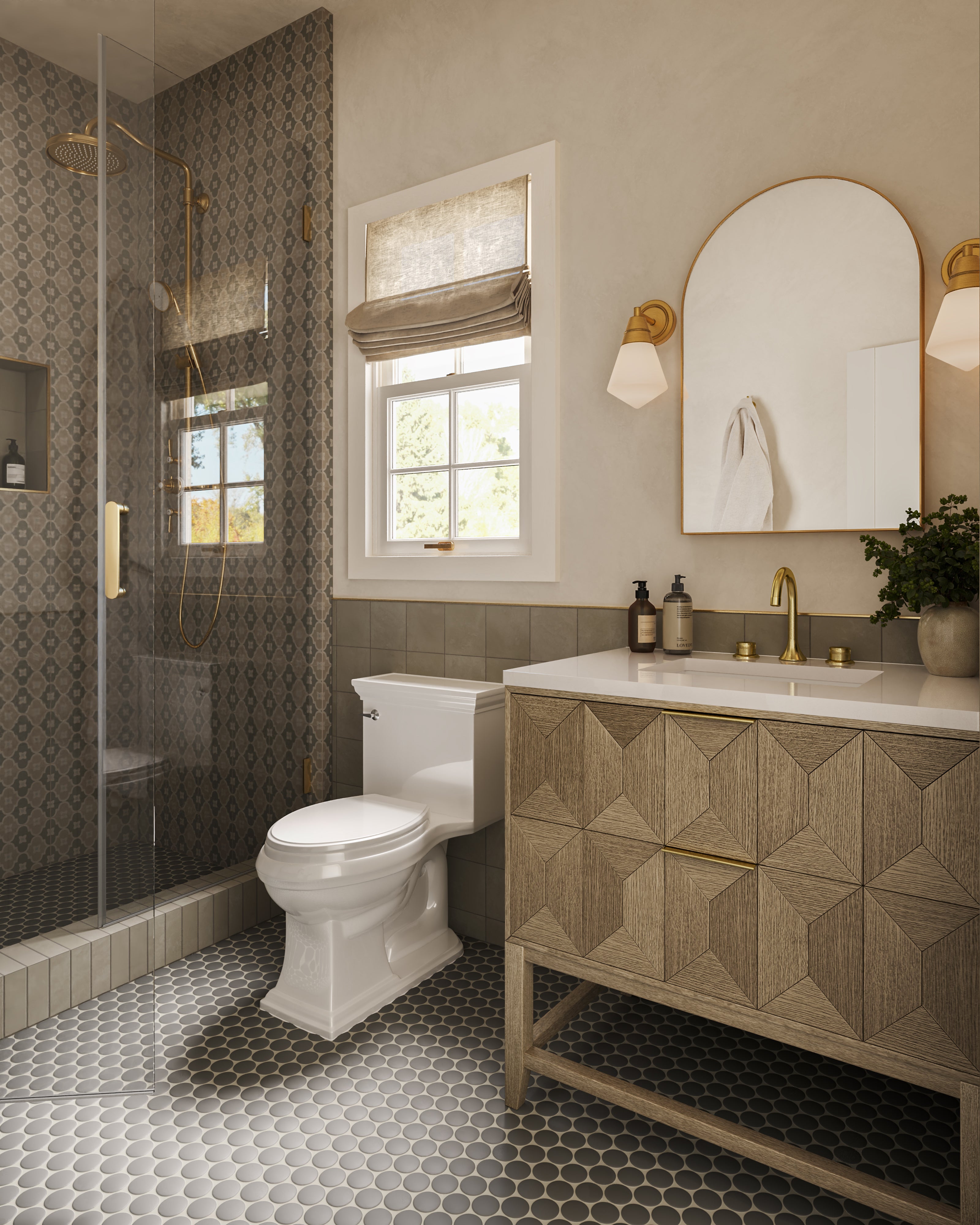 Brushed gold wall light with a geometric frosted glass shade casting soft light beside an arched mirror above a carved wood vanity.