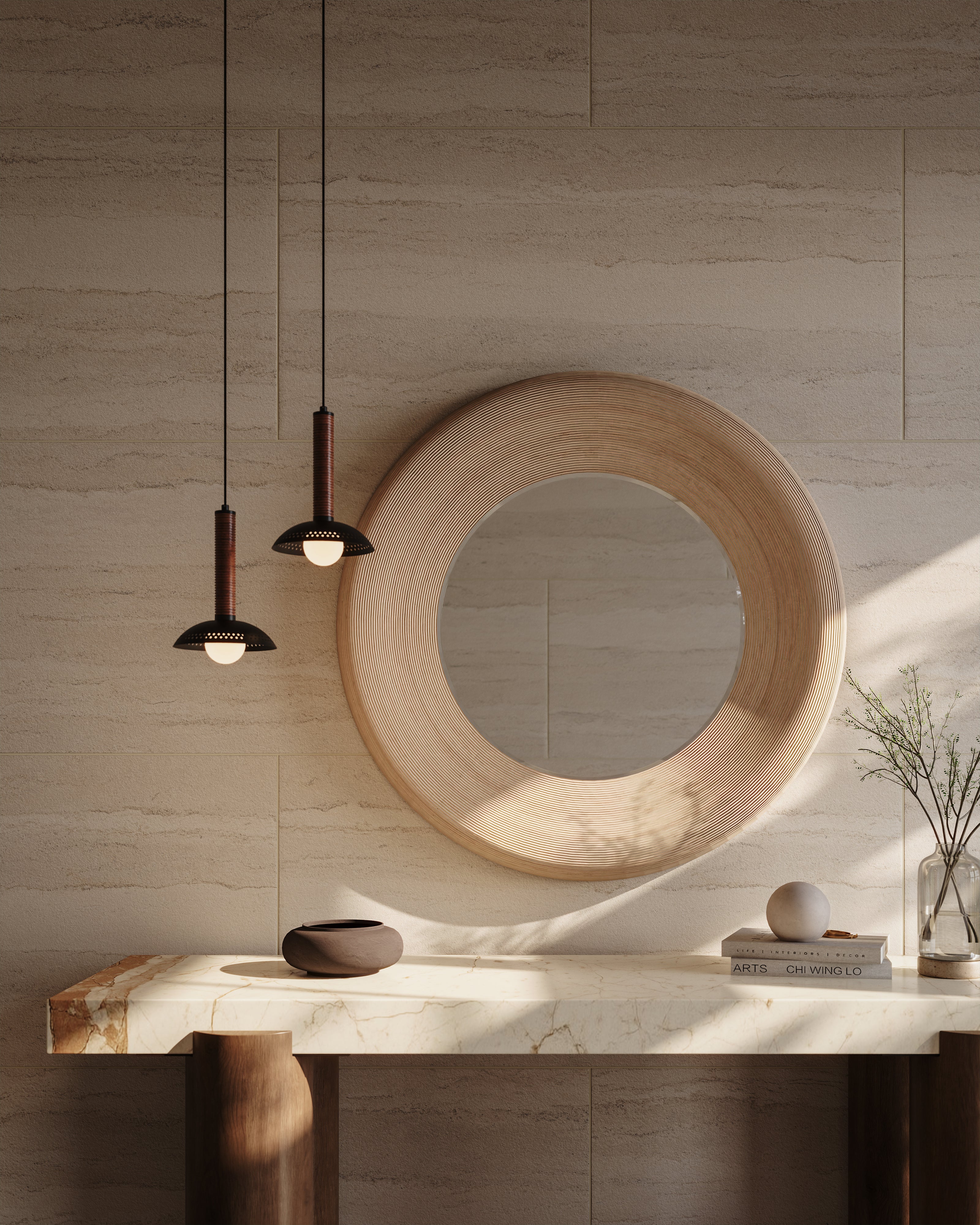 Round wood framed mirror above a marble console table, styled with ceramics and two black pendants with ribbed stems and dome shades
