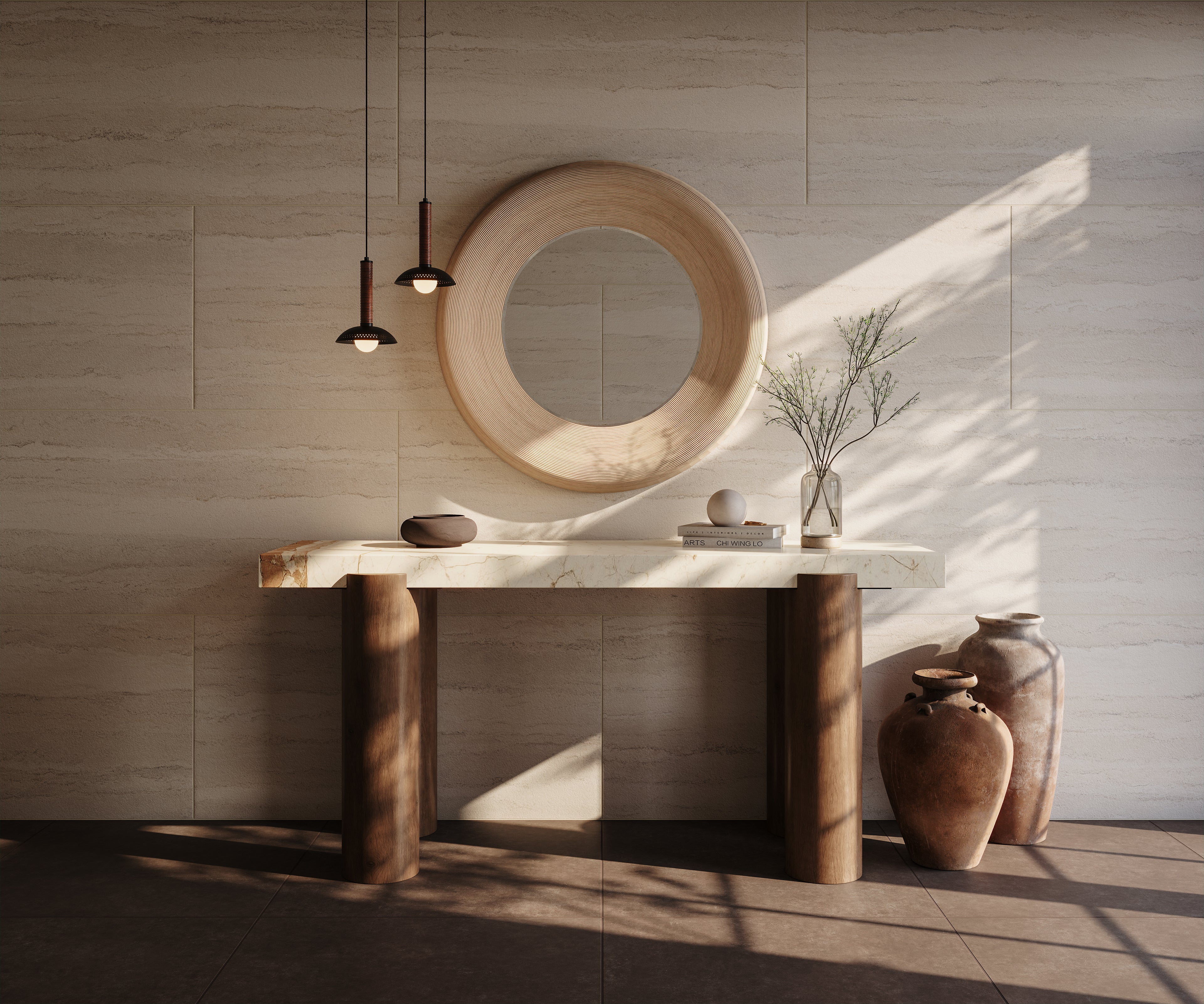 Sunlit console with marble top and wood legs, round mirror, ceramic vases, and two black pendants with ribbed stems and dome shades