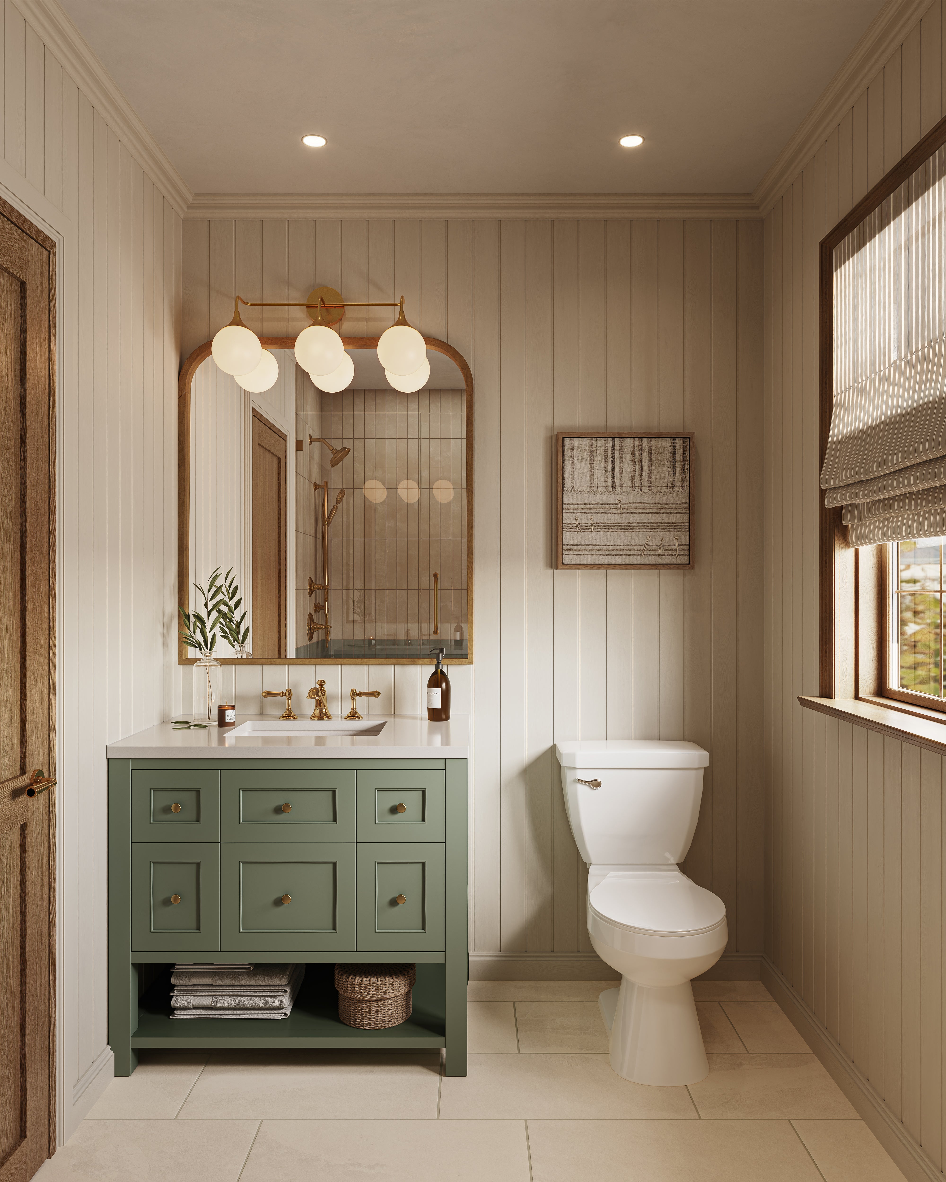 Gold globe vanity light above an arched mirror lighting a green vanity cabinet with brass faucet in a bright bathroom with vertical wall paneling.