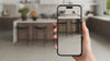 Video of a person holding an iPhone, using the AR feature to visualize digital tile samples in their existing kitchen, offering a realistic preview of potential home transformations.
